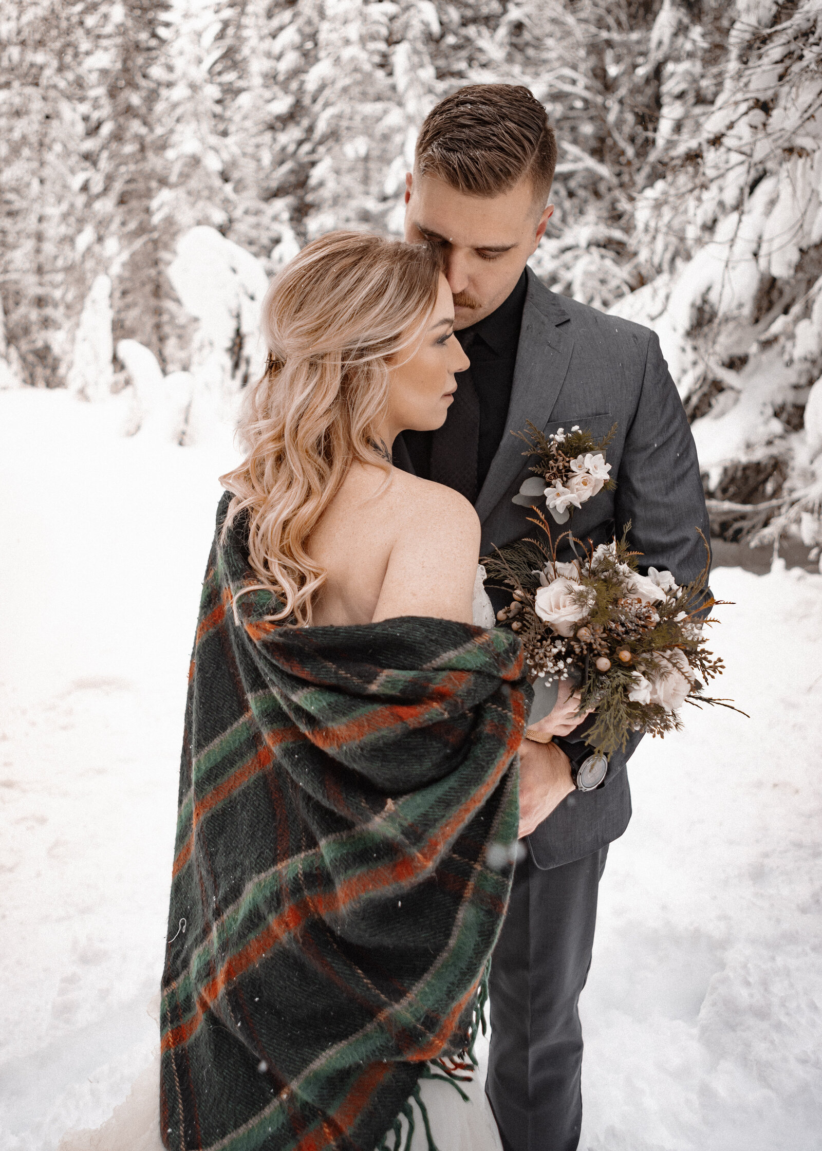 Couple Snuggling in the snow following their winter elopement on Mount Hood