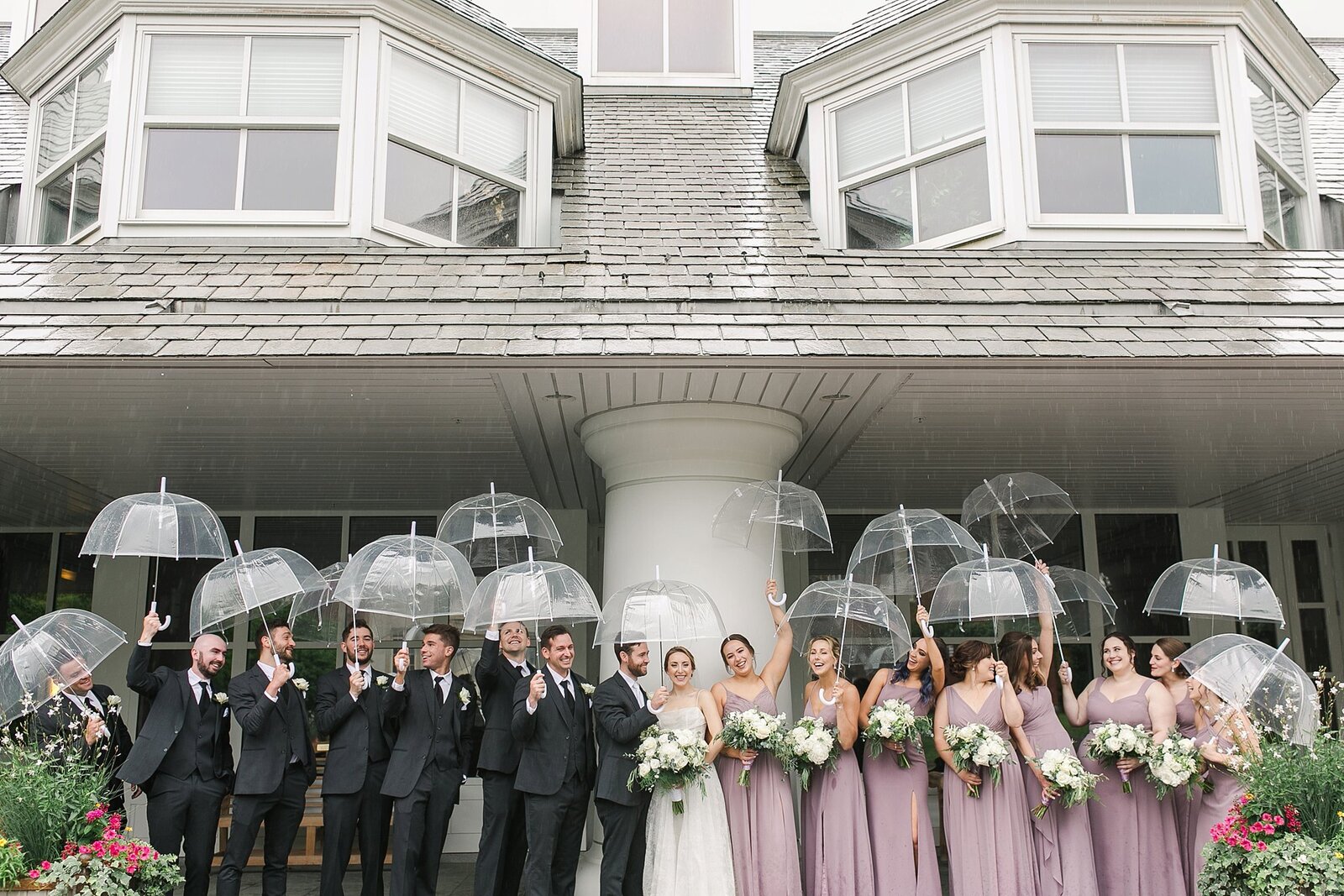 Wedding party hold up clear umbrellas on rainy wedding day in State College, PA by the Jepsons.