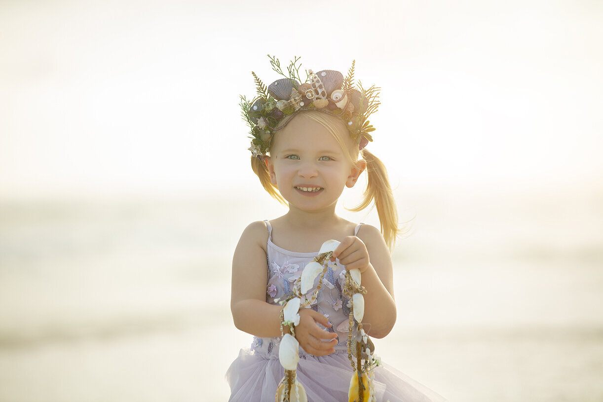 Girl playing with sea shells on Destin Beach, Dallas Family Photographer