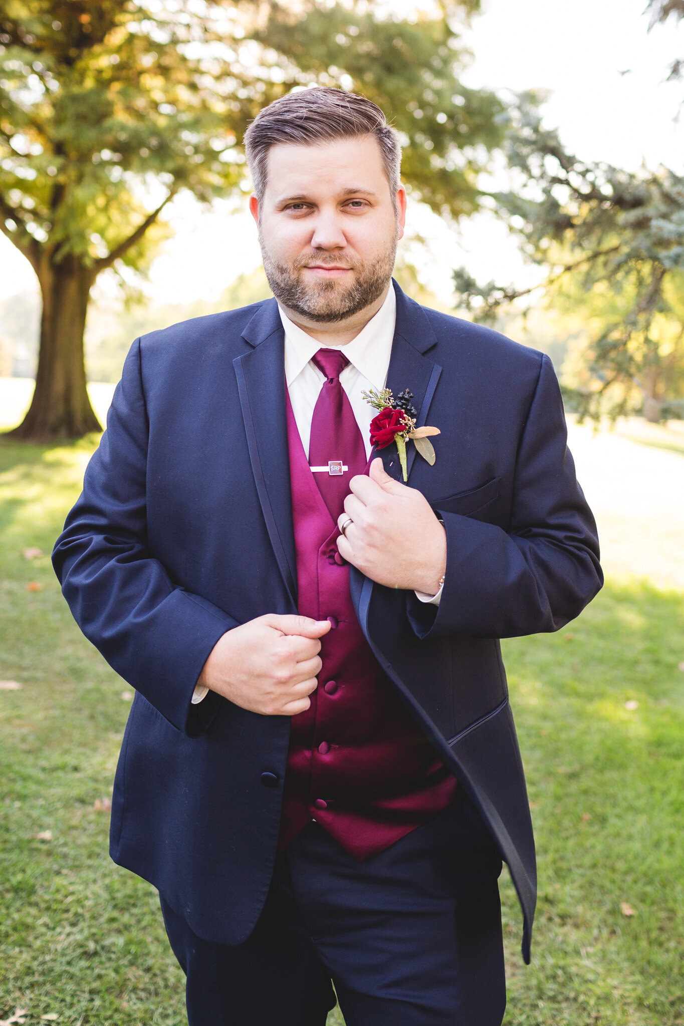 dapper groom posing for wedding day photographer in ohio
