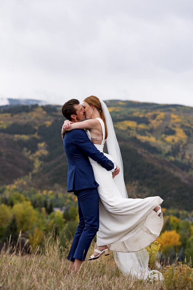 couple swaying in field with fall  leaves