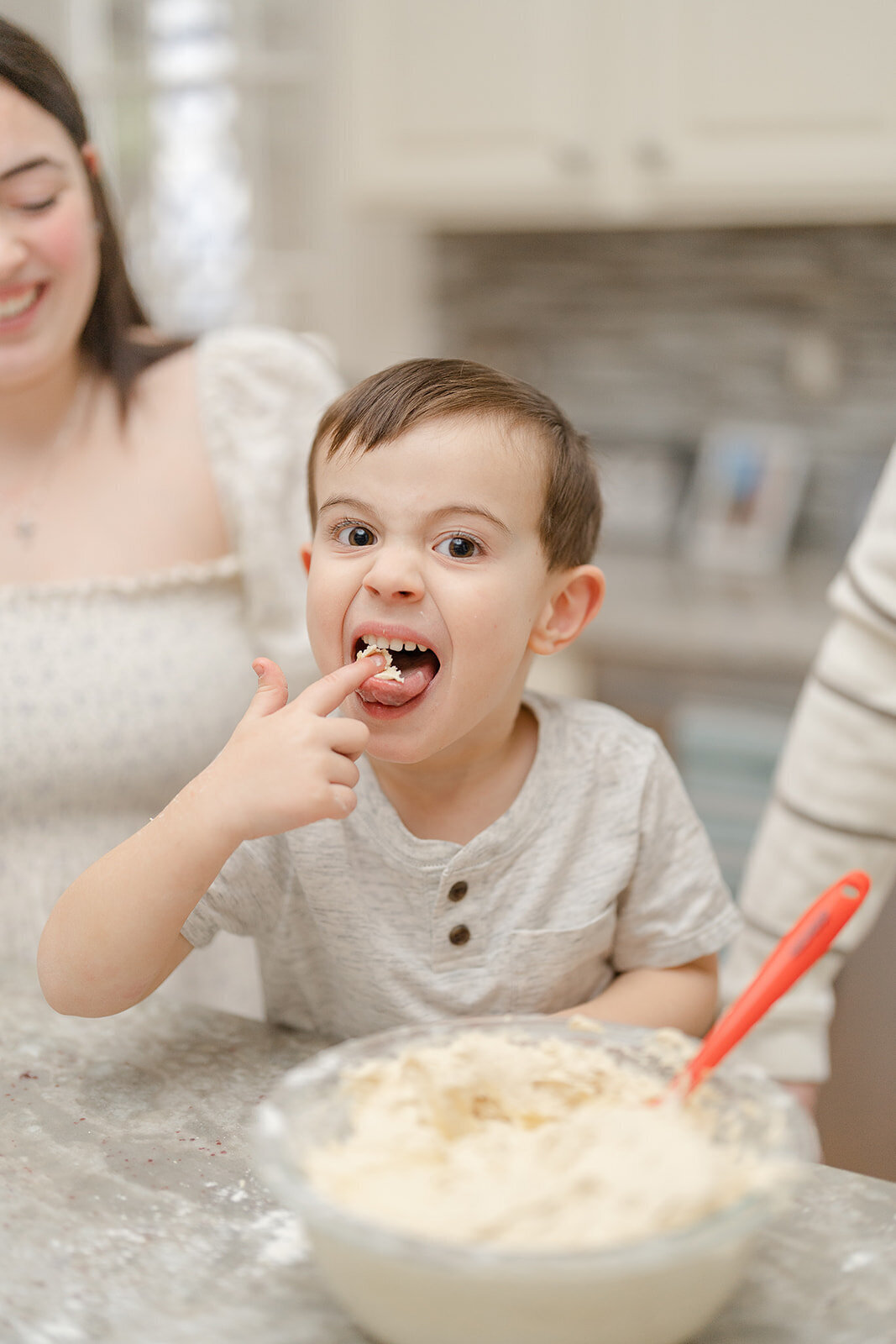 boy eat batter during indoor family photos in Fairfax County, Virginia