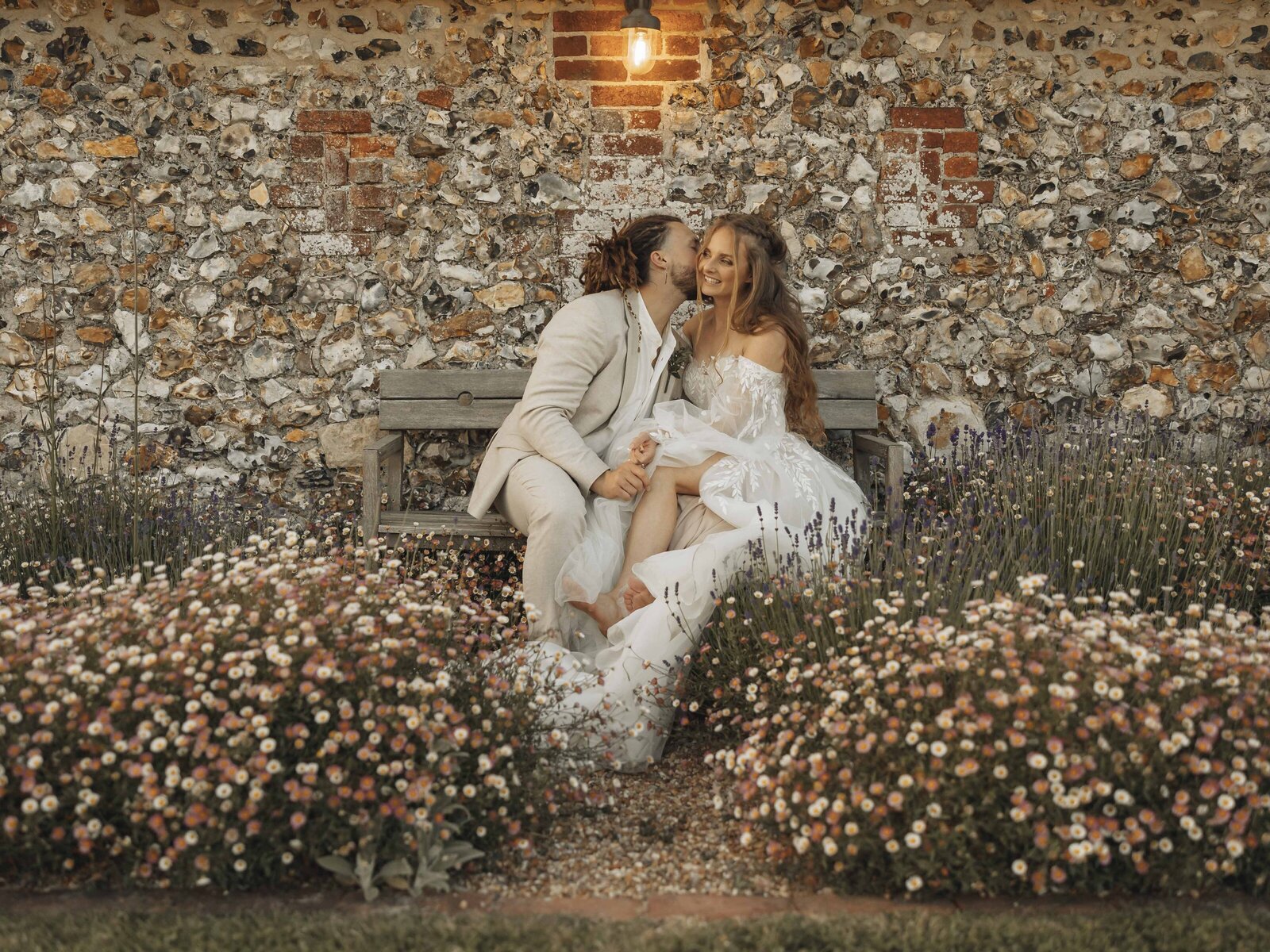 bride and groom sat on bench