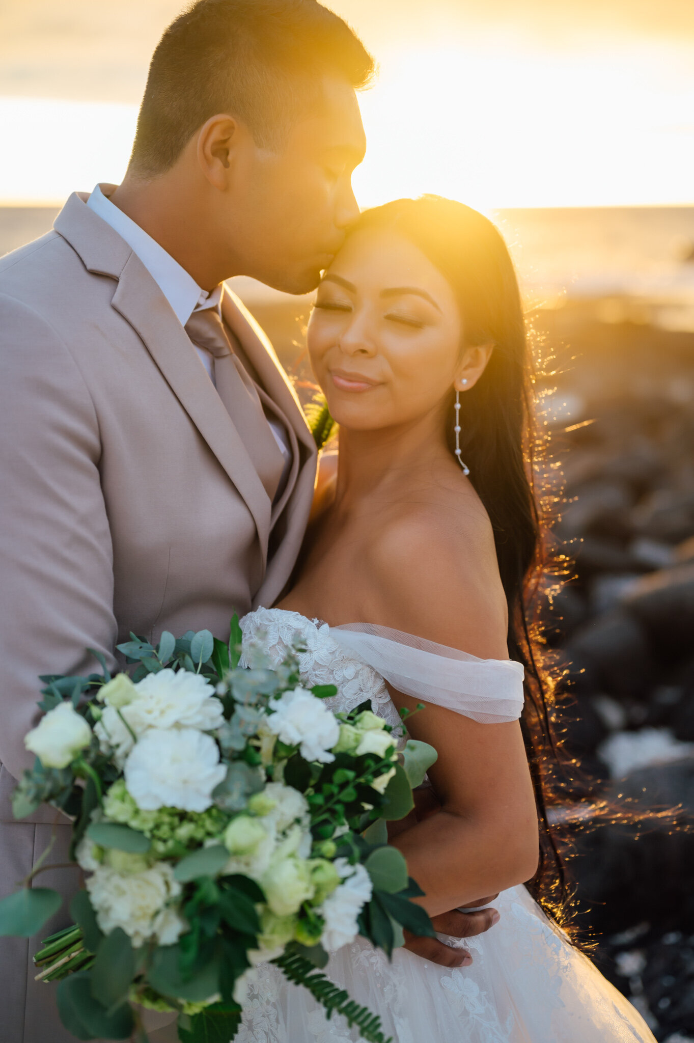 sunset glow as groom kisses his bride