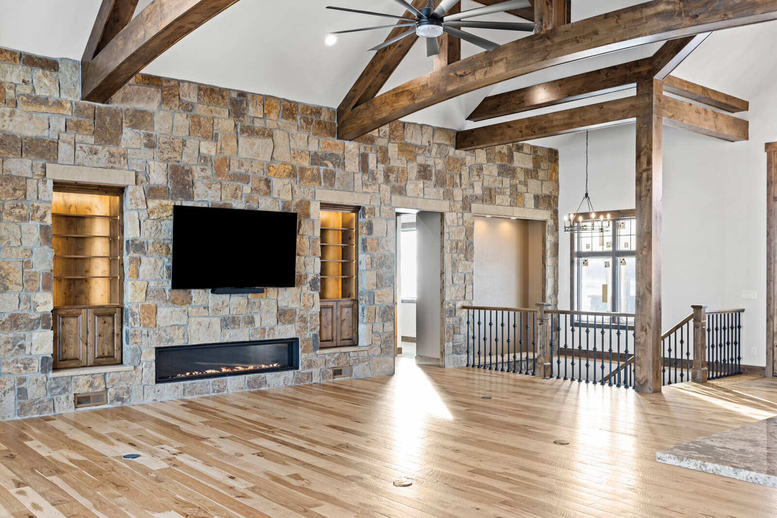 rustic stone wall with gas fireplace and tv