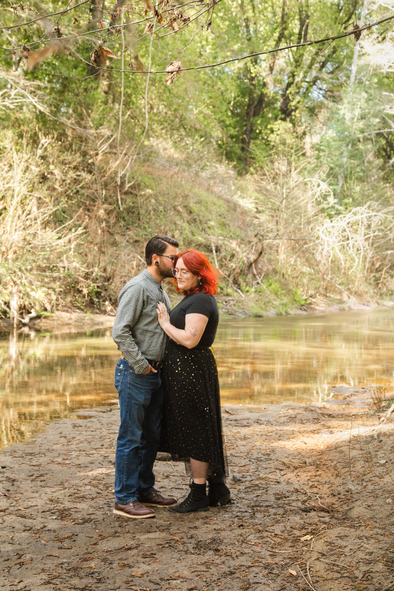 An tattooed engaged couple poses for photos in a redwood forest in Santa Cruz, Ca.