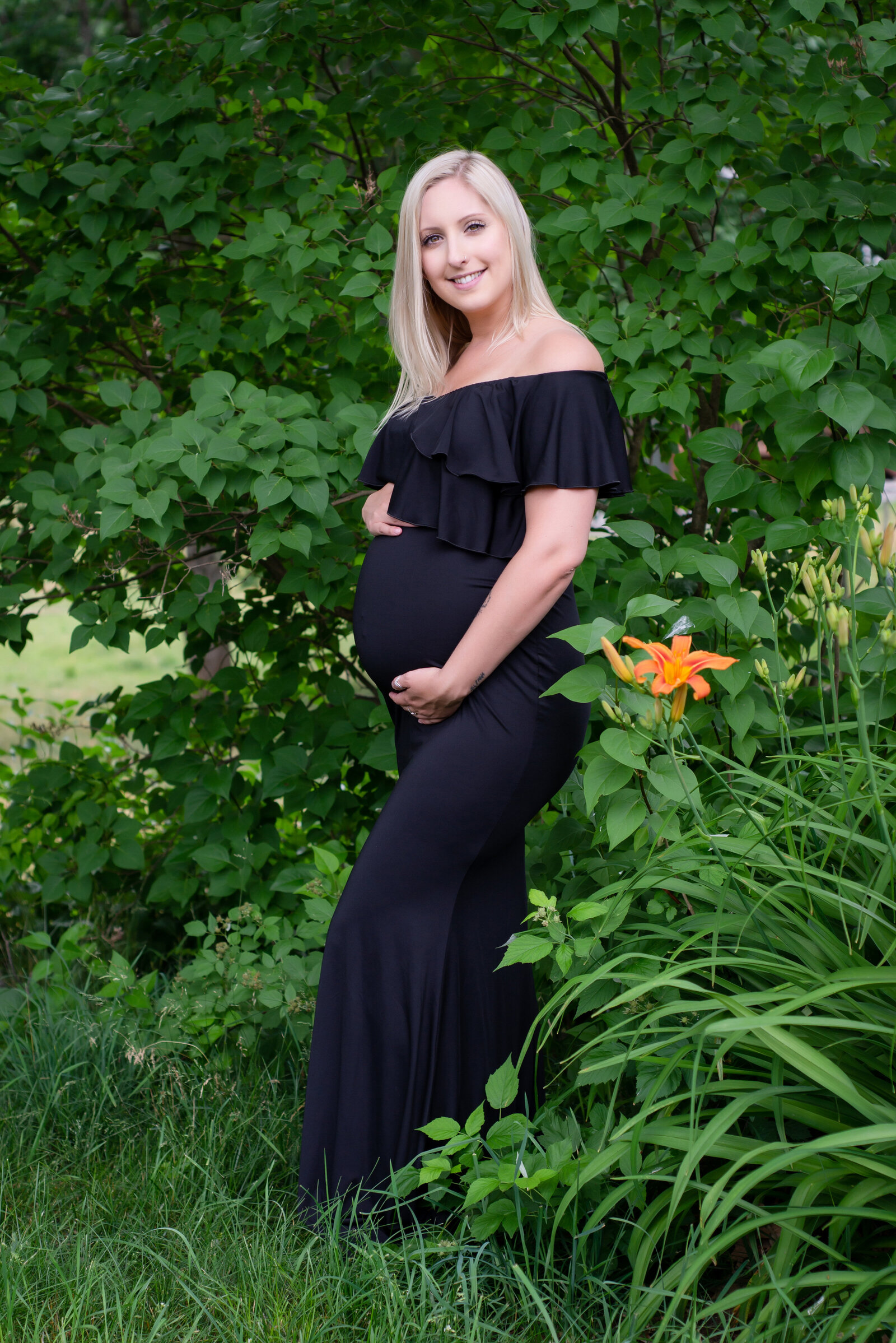 Pregnant woman in maternity photo in garden country setting