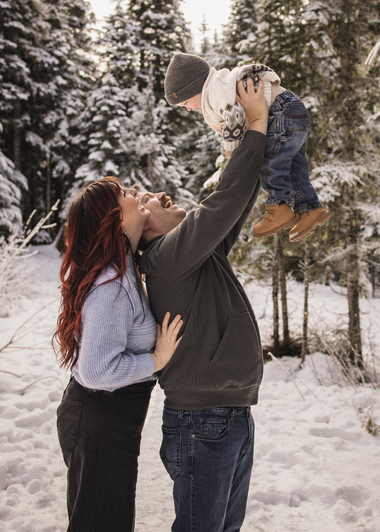 Family of 3 playing in the snow on mount hood