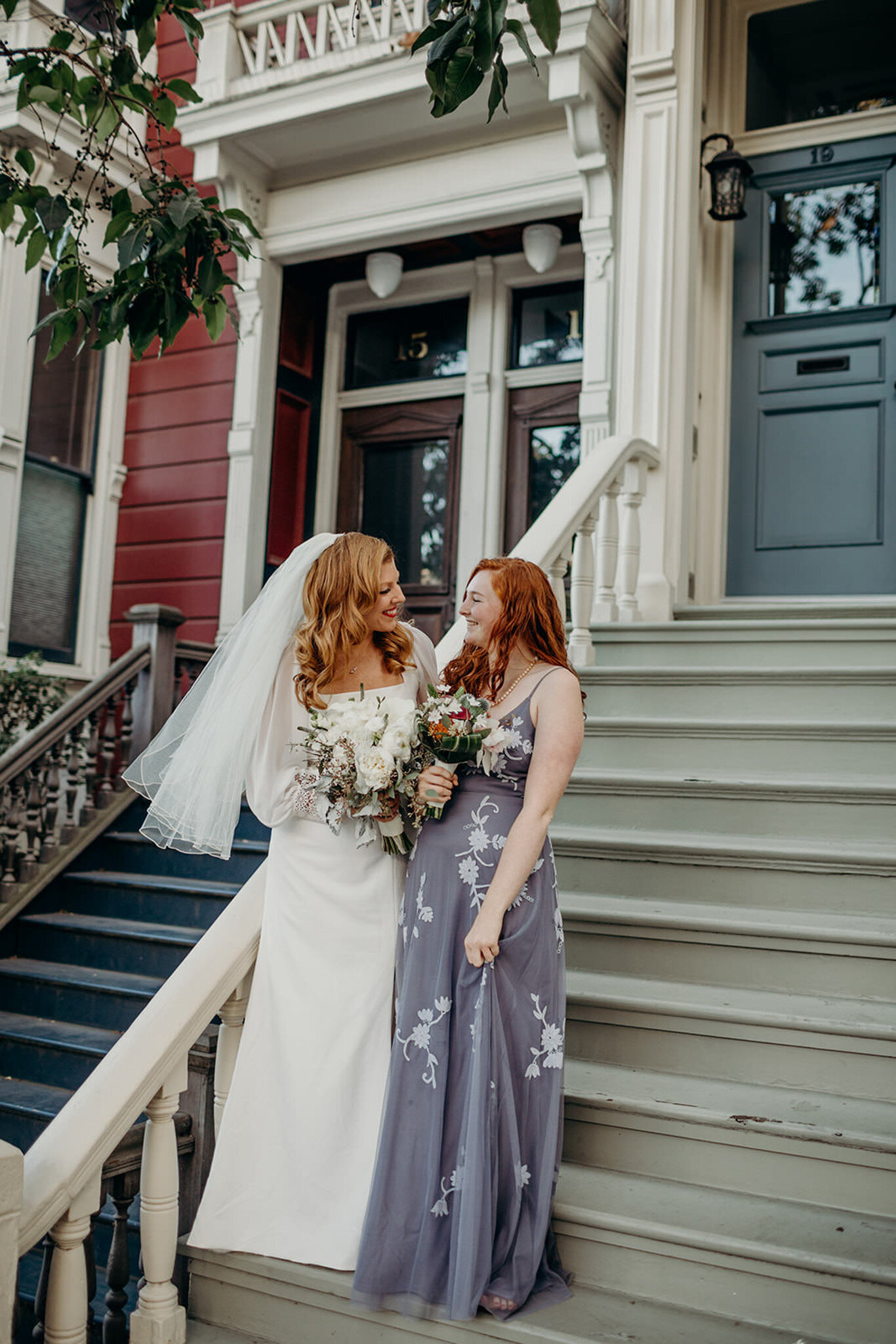 bride and bridesmaid on steps of a san francisco walk up
