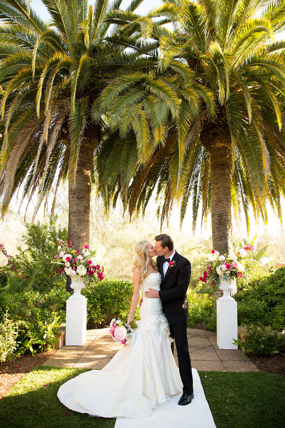 Bright colors an palm trees frame this elegant couple