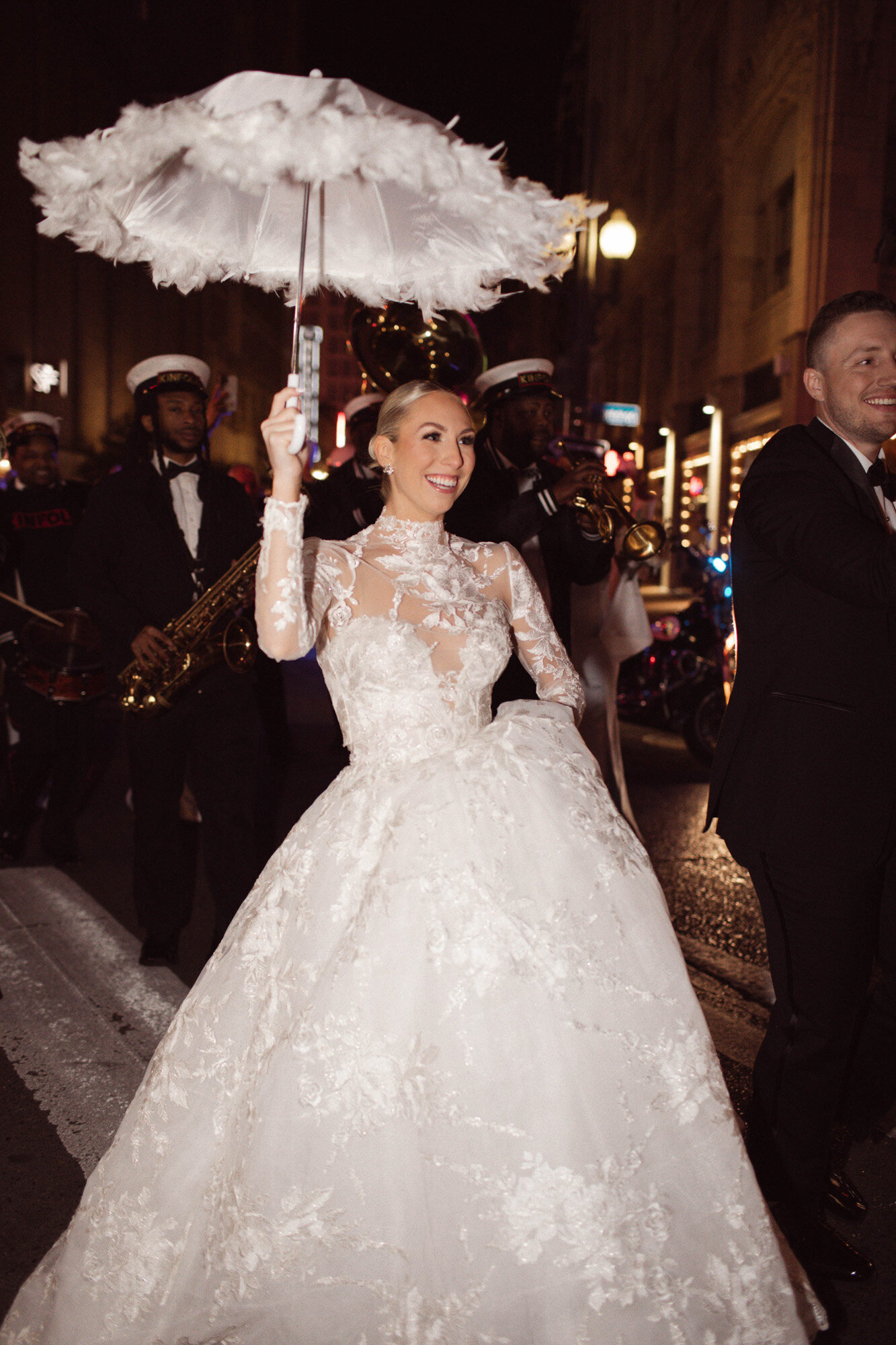 bride walking down street at night with umbrella