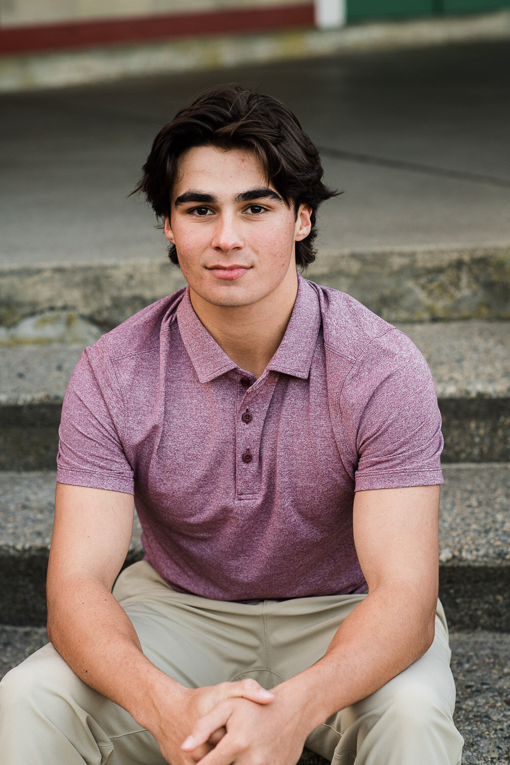 senior boy serious sit on steps