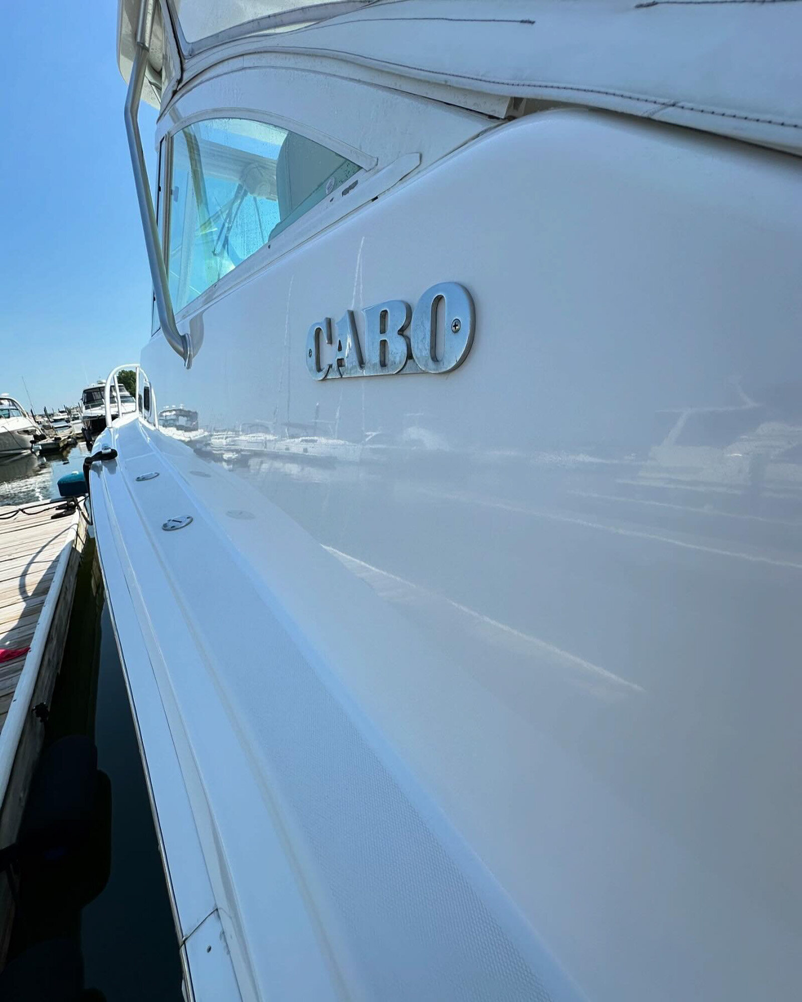 Side view of a polished white Cabo yacht
