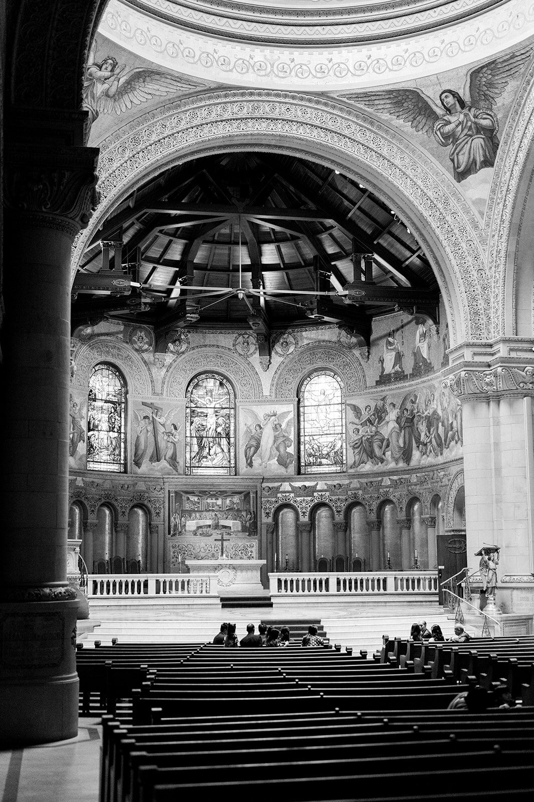 The majestic interior of Stanford Memorial Church, showcasing its intricate design and breathtaking stained-glass windows during a wedding ceremony.