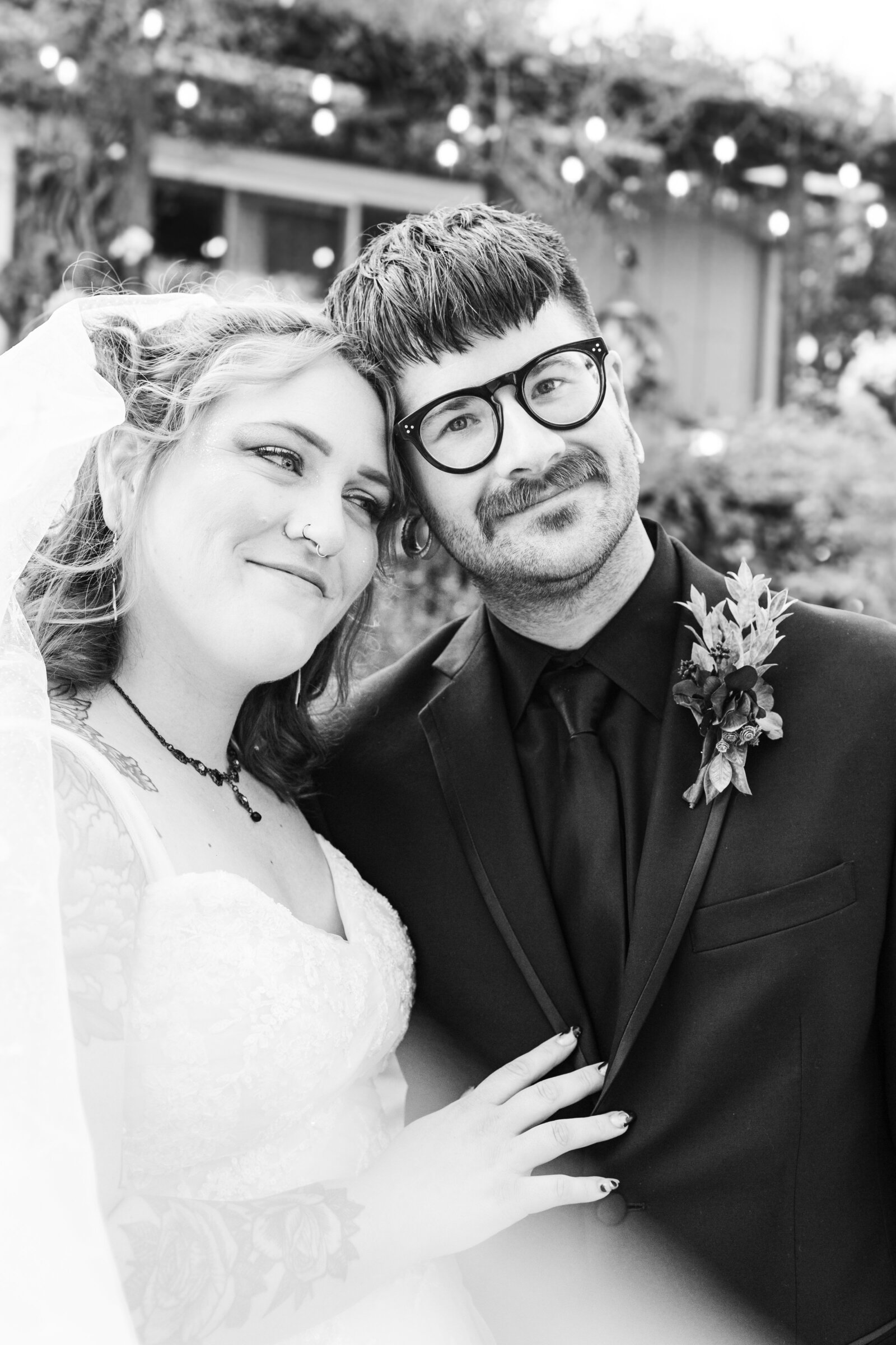A night under the stars themed wedding, with a moon cutout. A newlywed bride and groom.