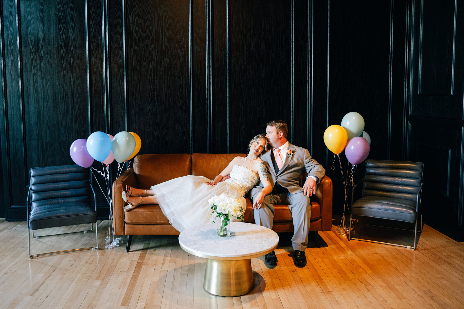 Bride and Groom on couch with ballons