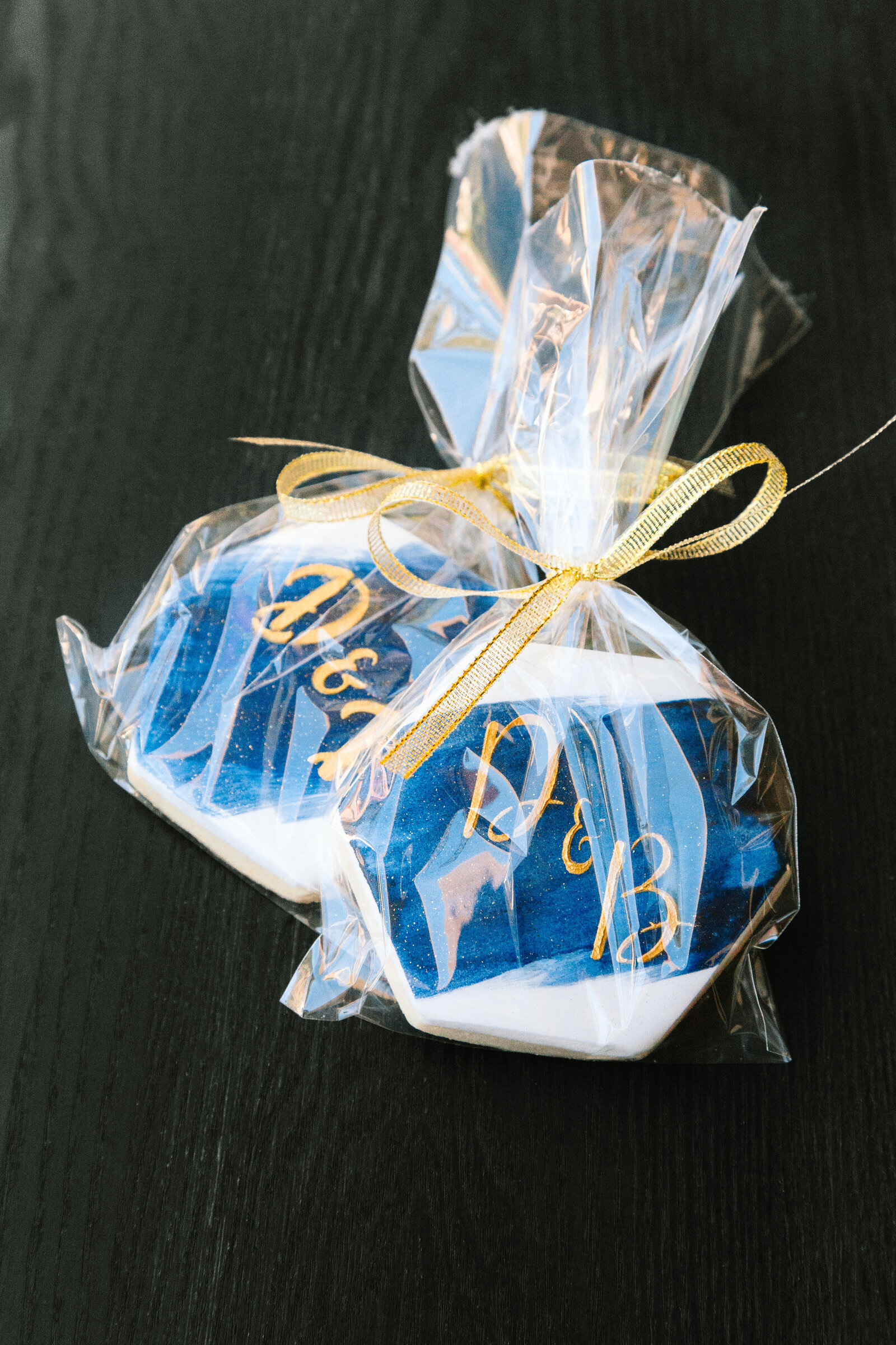 Homemade blue and gold cookies as wedding favors.