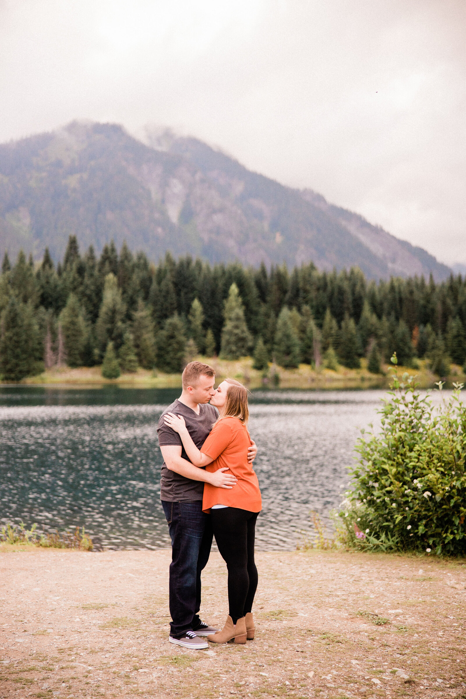 Man and woman kissing at Gold Creek Pond, one of the best places for engagement photos in seattle