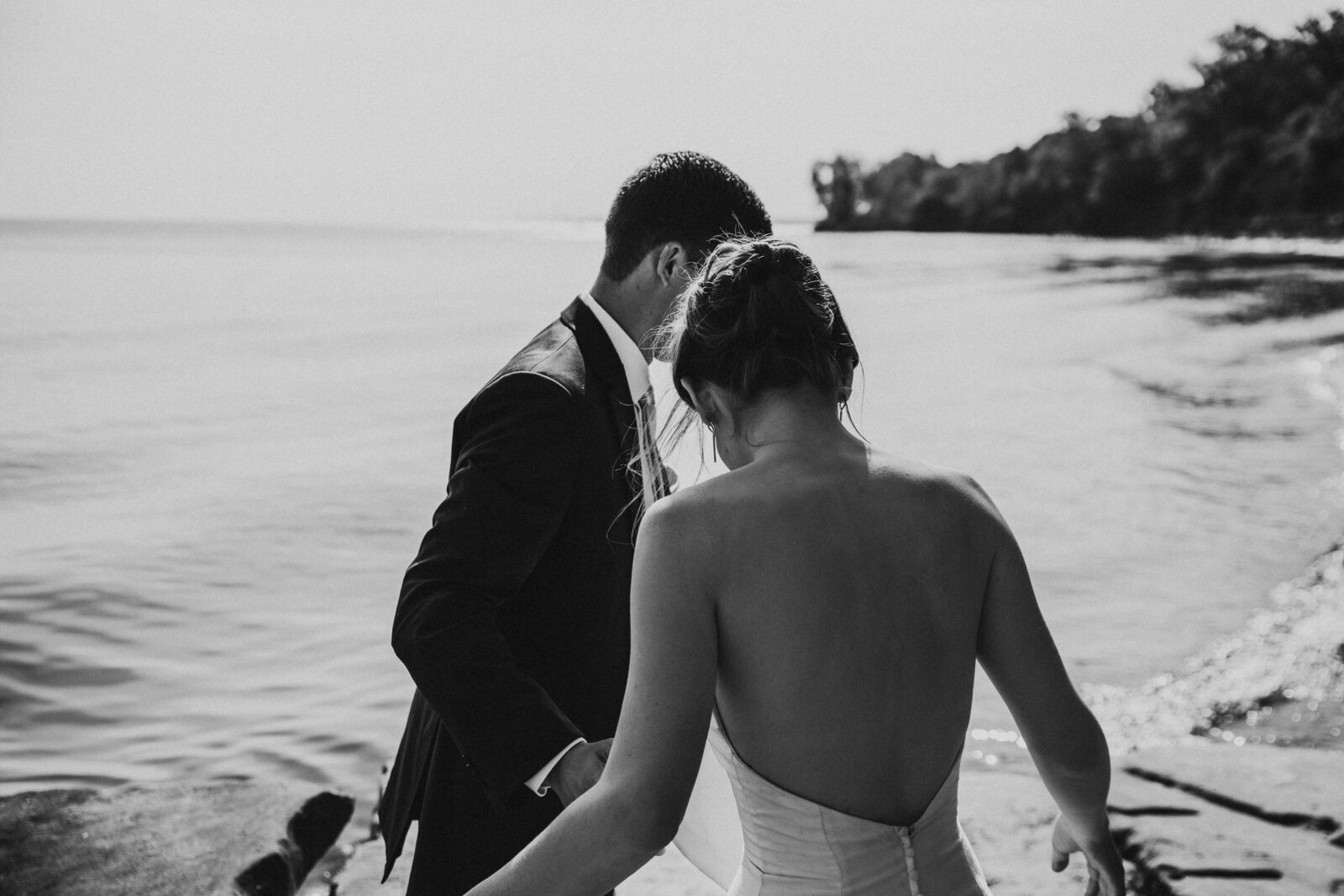 Black and white image of wedding couple at intimate beach wedding,