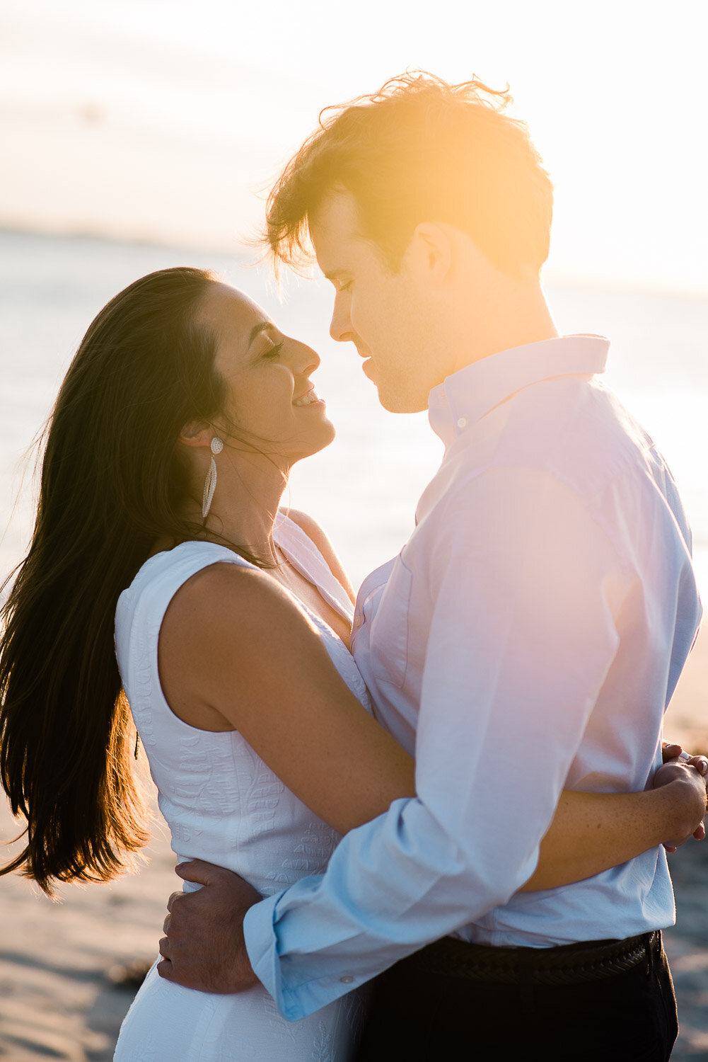 couple face each other in sunlight