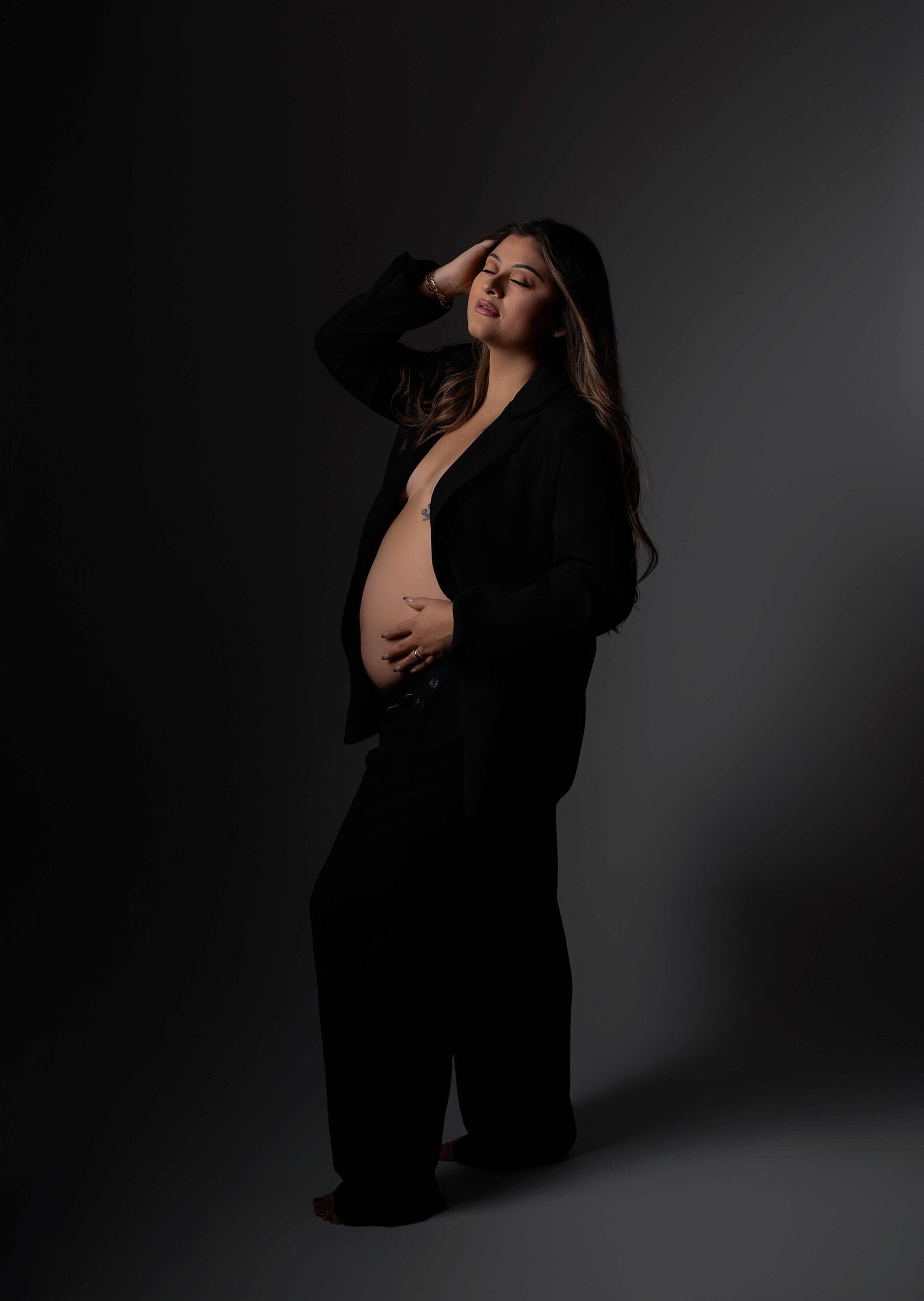 Mom wearing a suit with moody liighting