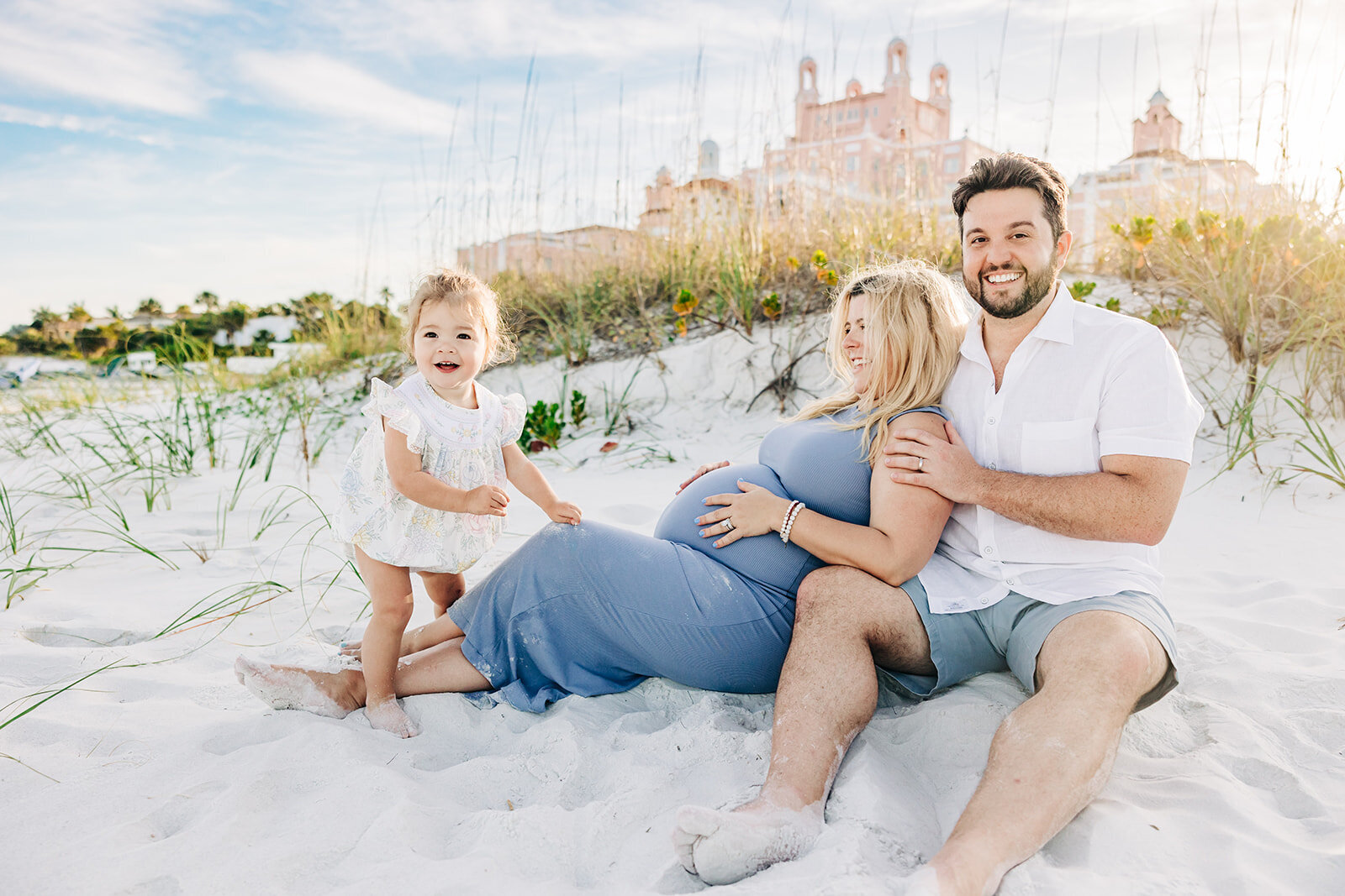 St. Pete beach maternity family photo on the beach playing with thier daughter