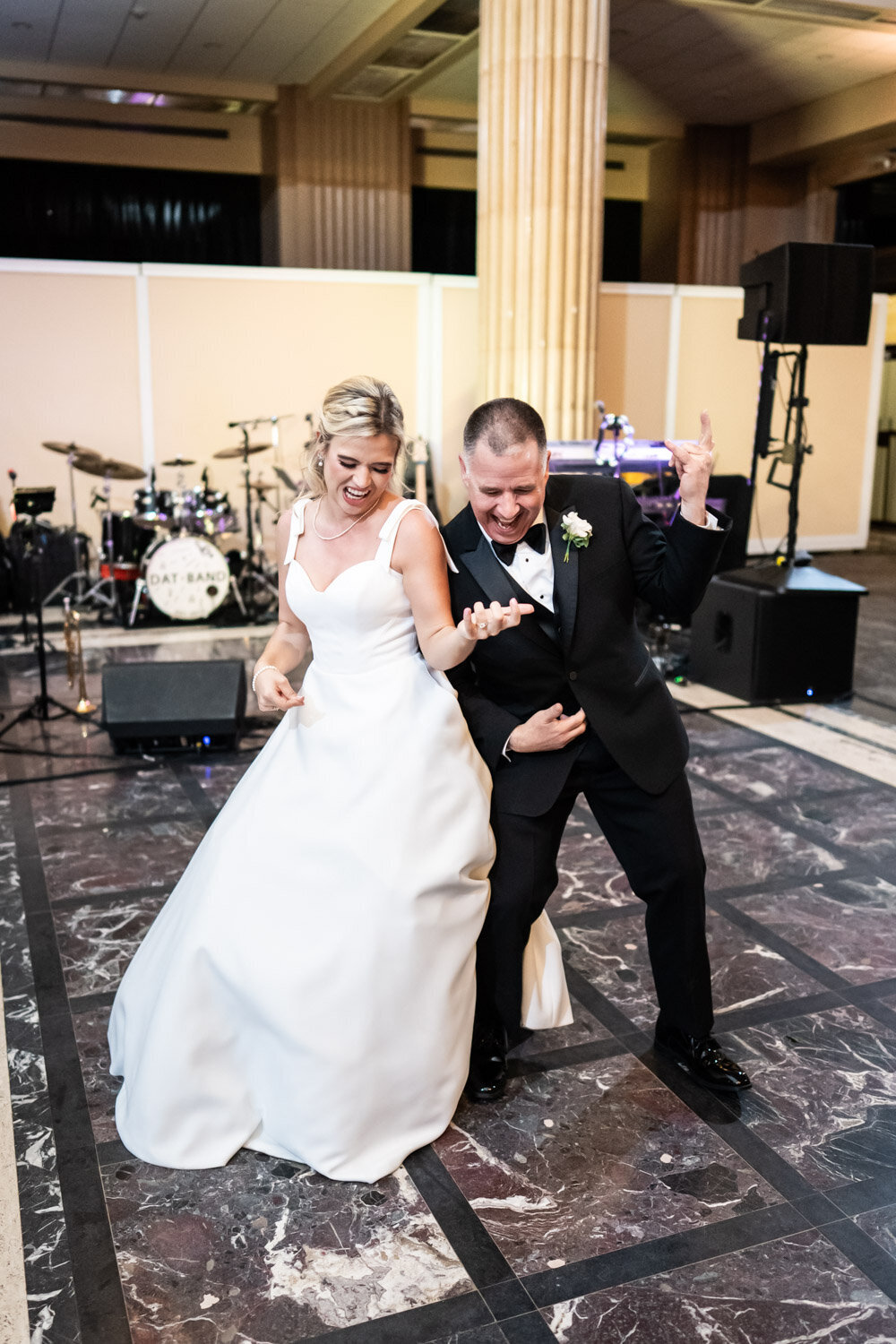 Bride and father play air guitar during dance at Capital on Baronne wedding