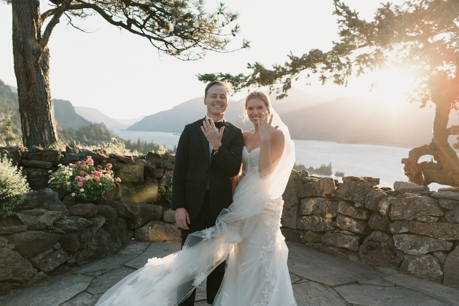 bride and groom holding their rings up on their wedding day