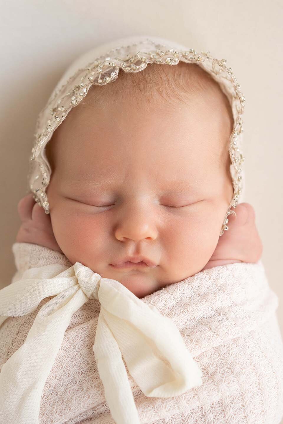 close-up-of-newborn-wearing-a-bonnet