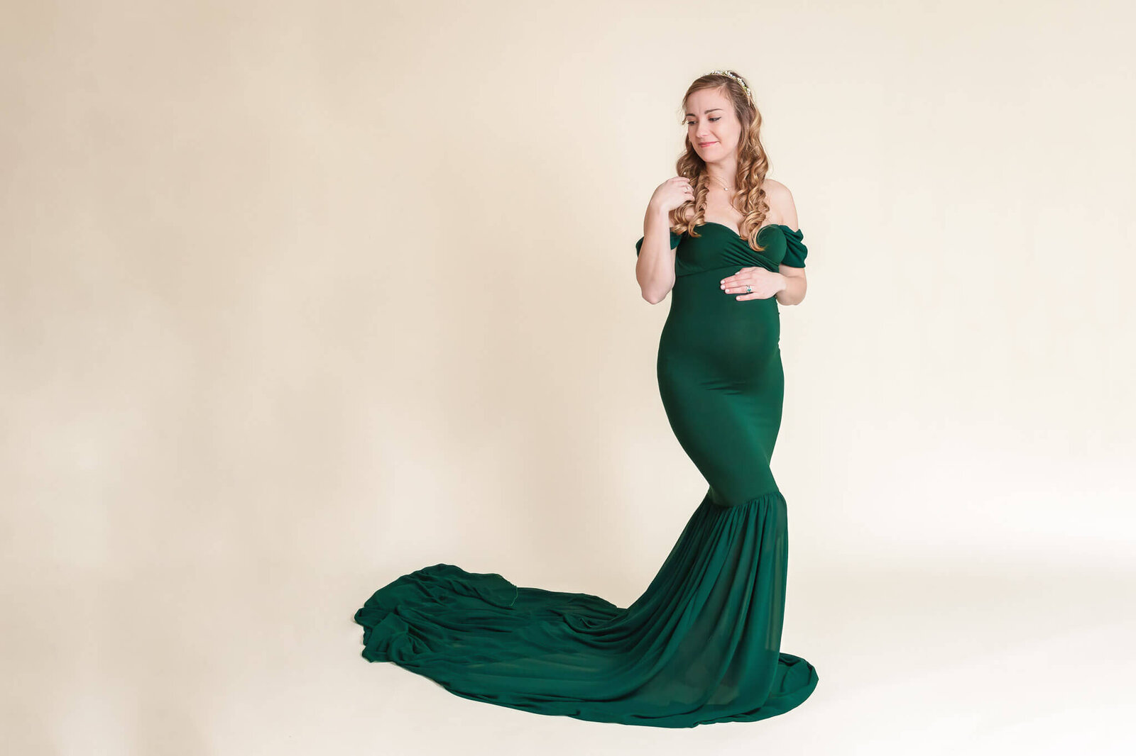 A pregnant woman posing in a Northern Virginia maternity studio.