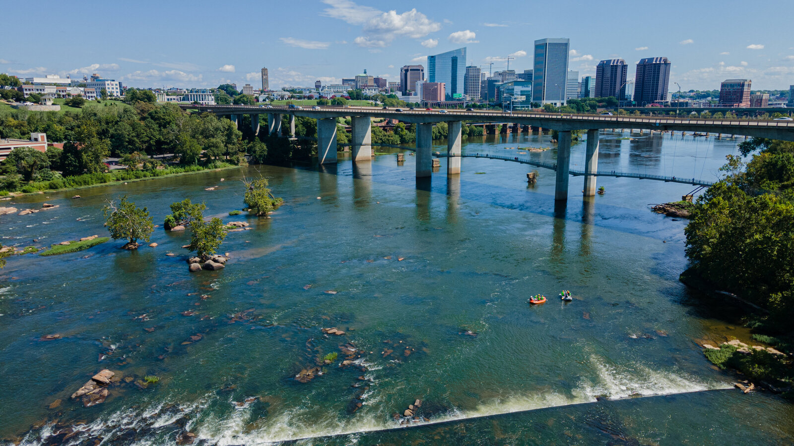 overhead drone photography of richmond virginia river and bridge with boaters by emmiclaire photography
