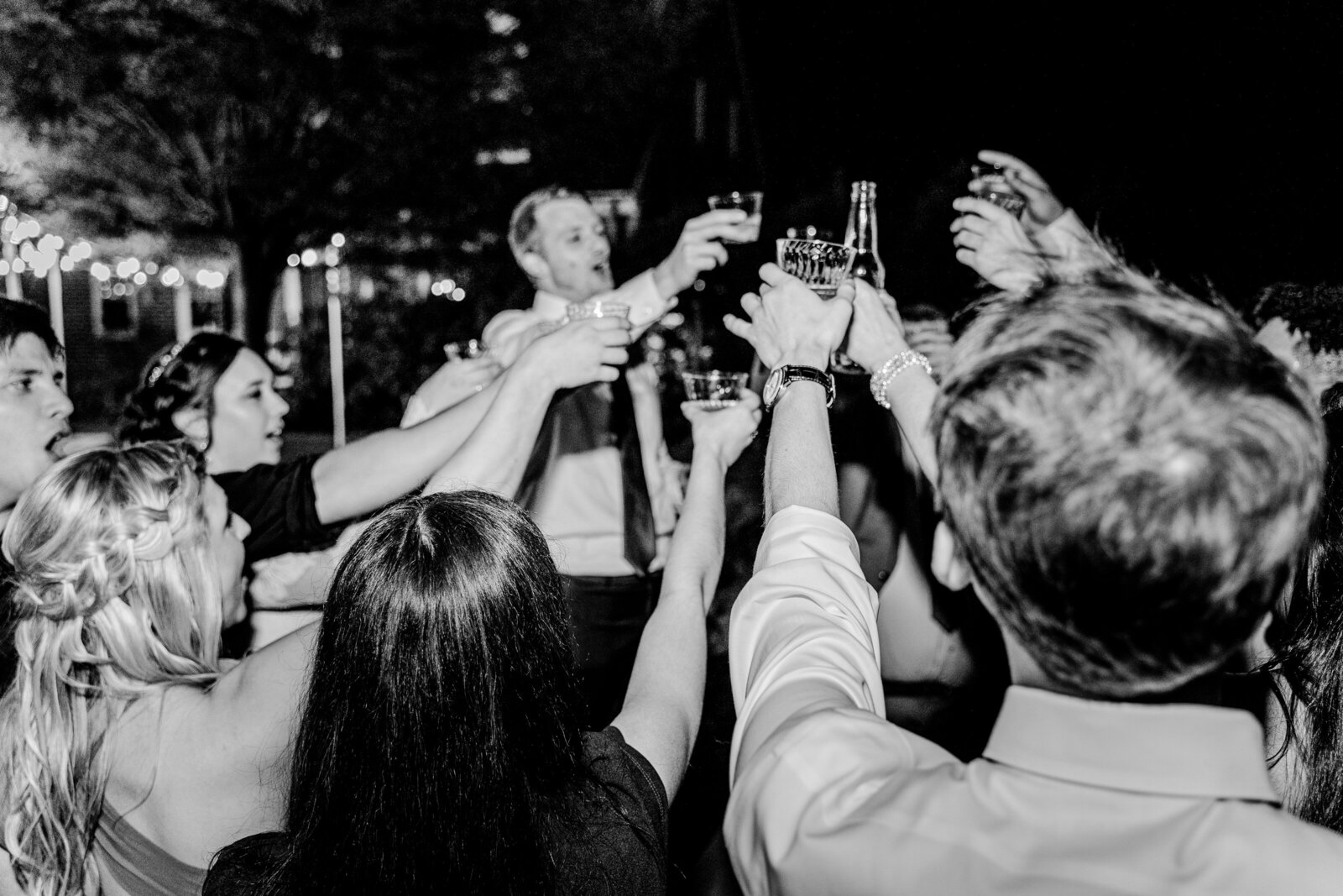 A groom and wedding guests share a toast during their wedding at Gunston Hall in Northern Virginia