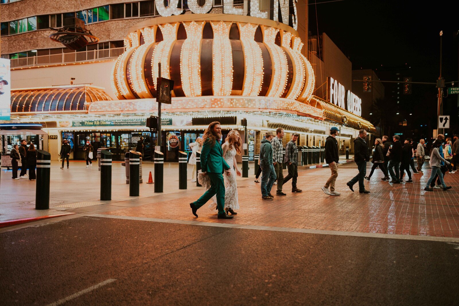 Couple walking together along Fremont Street at night.