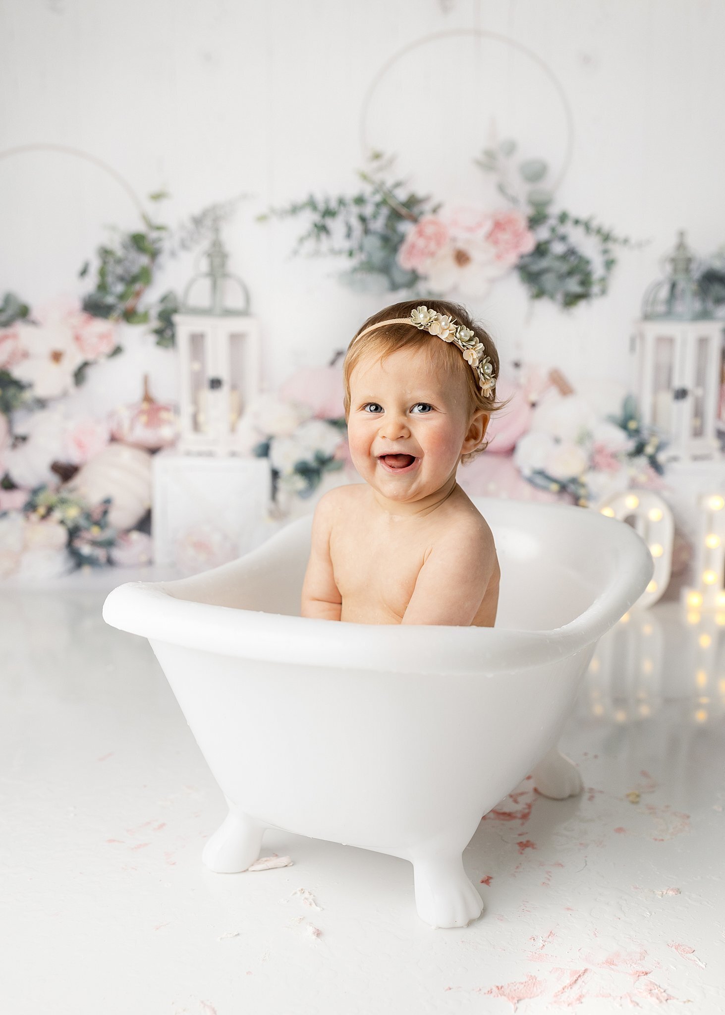 baby girl in a tub smiling