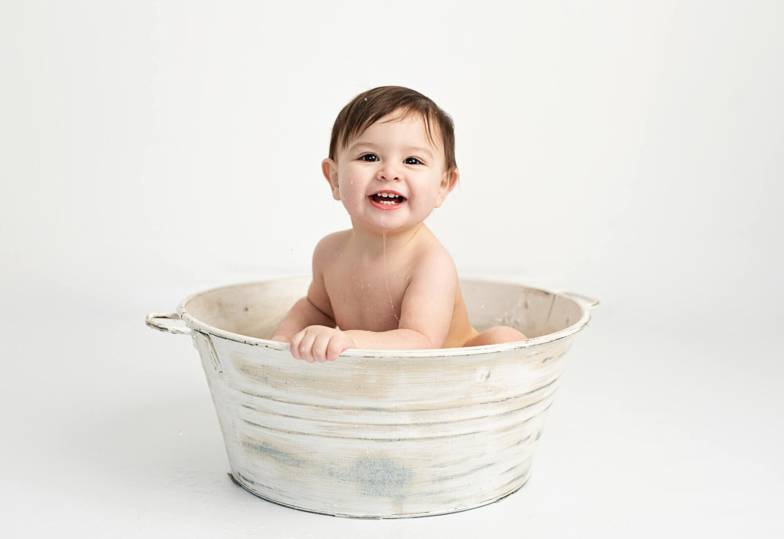 Baby laughing in splash bath vintage tub