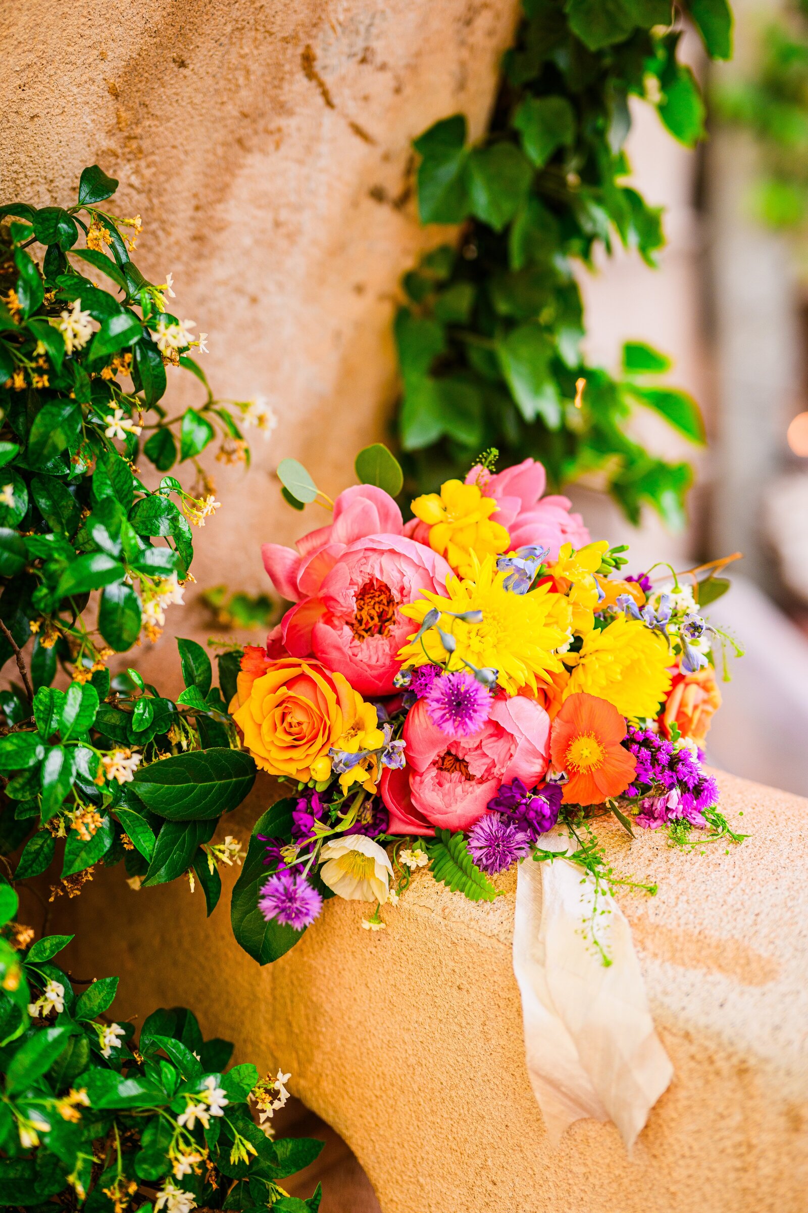 colorful wedding bouquet sitting on ledge at Tlaquepaque Village in Sedona