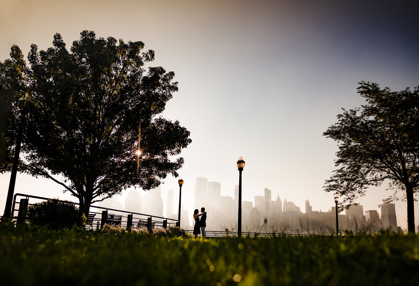 Capture your engagement with NYC skyline views at Liberty State Park with Ishan Fotografi.