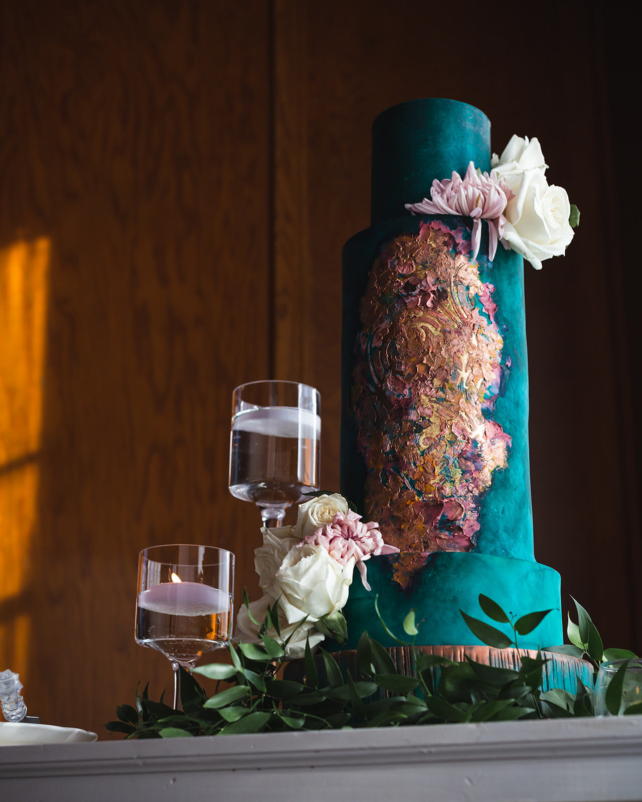 teal watercolor wedding cake decorated with florals