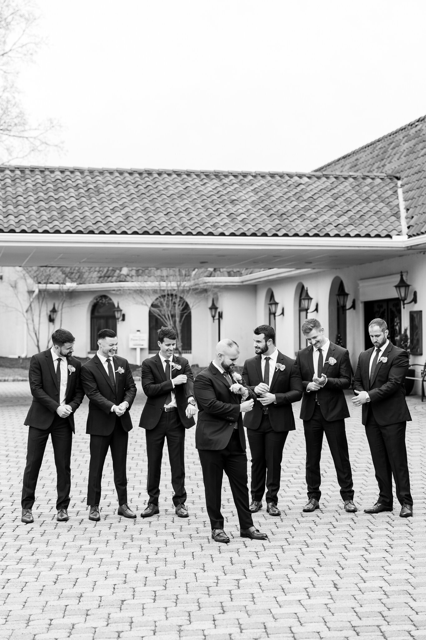 Classic black and white photo of the groom and groomsmen standing together at Perona Farms.
