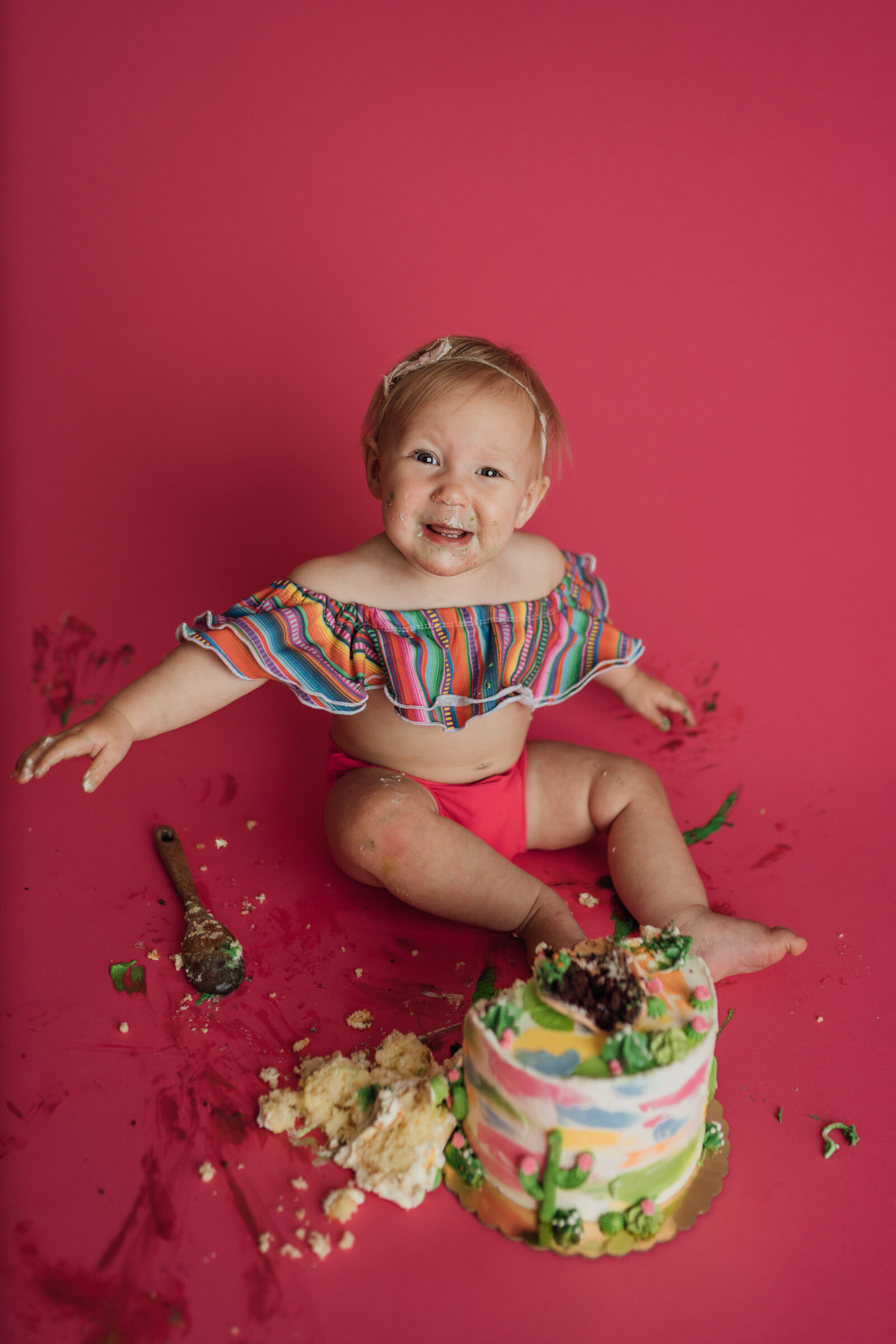 girl eating taco cake during cake smash photography session in Tampa