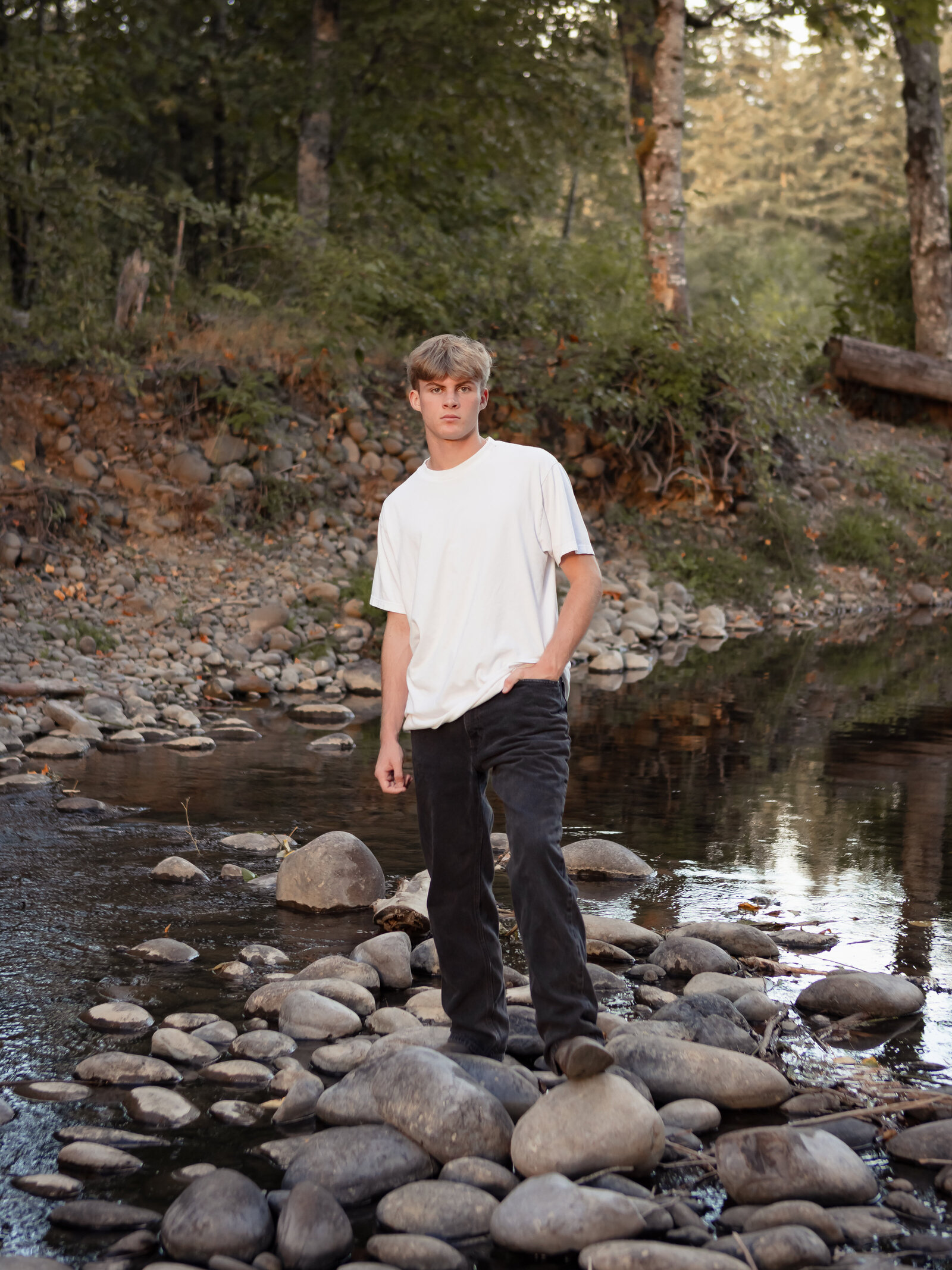 boy standing by river for senior portraits at Milo Mciver Park