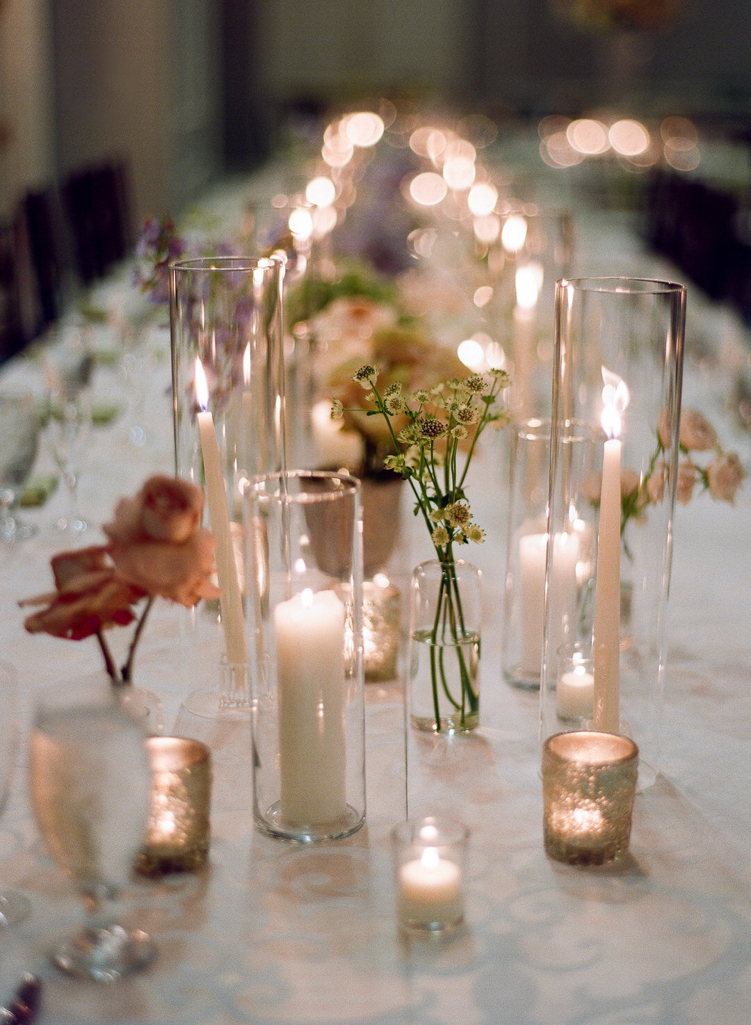 Wedding Reception table filled with flowers and candles