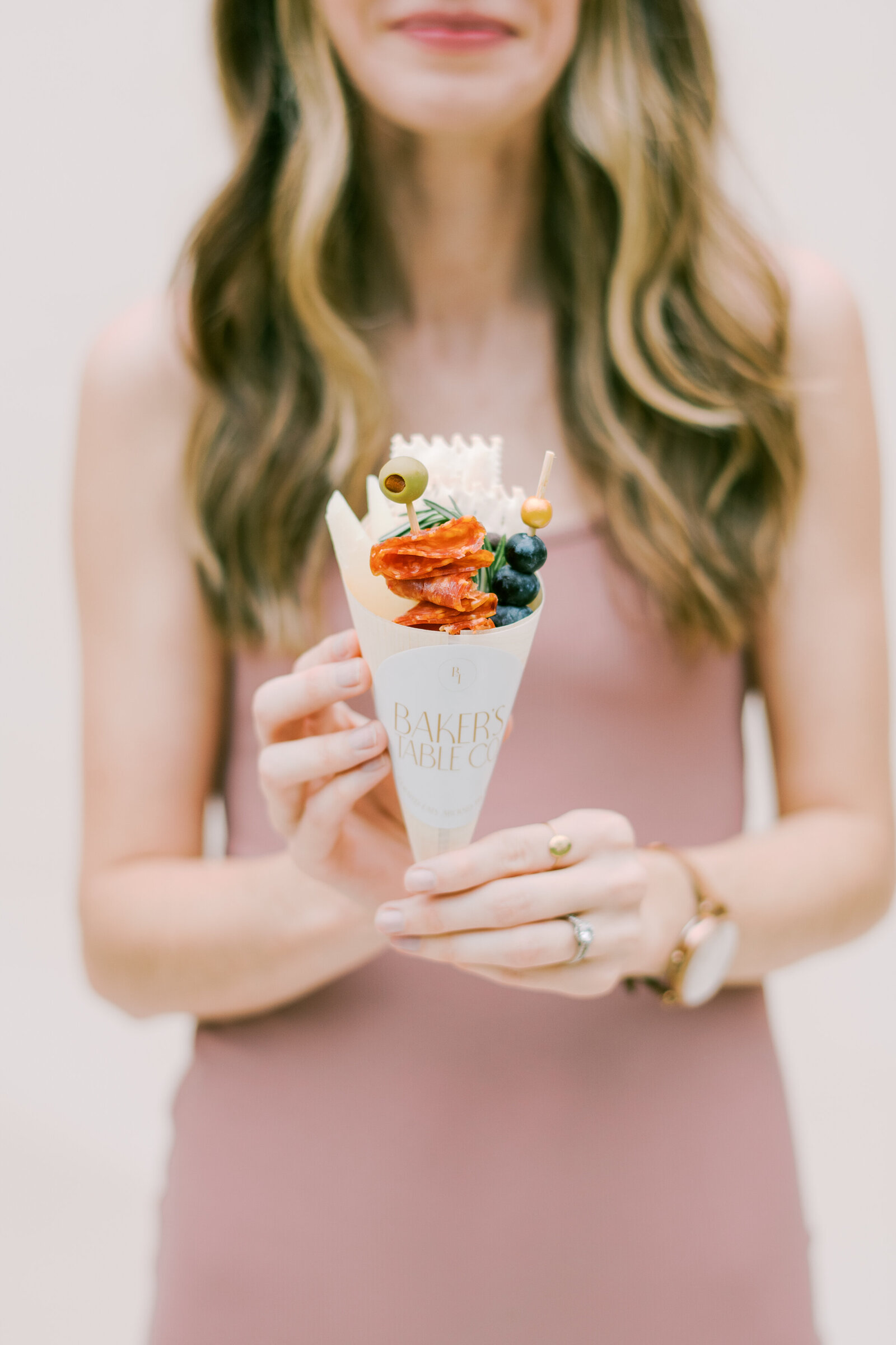 Close up of girl holding charcuterie cone