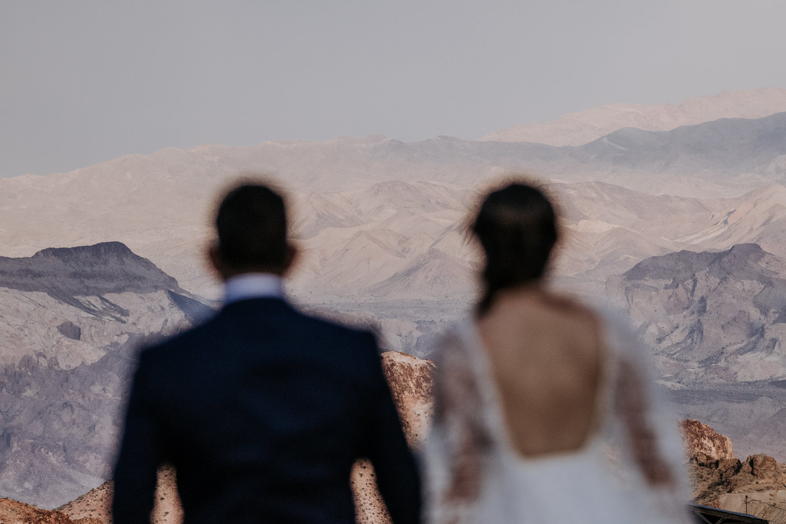 bride and groom enjoy desert view near ghost town in las vegas