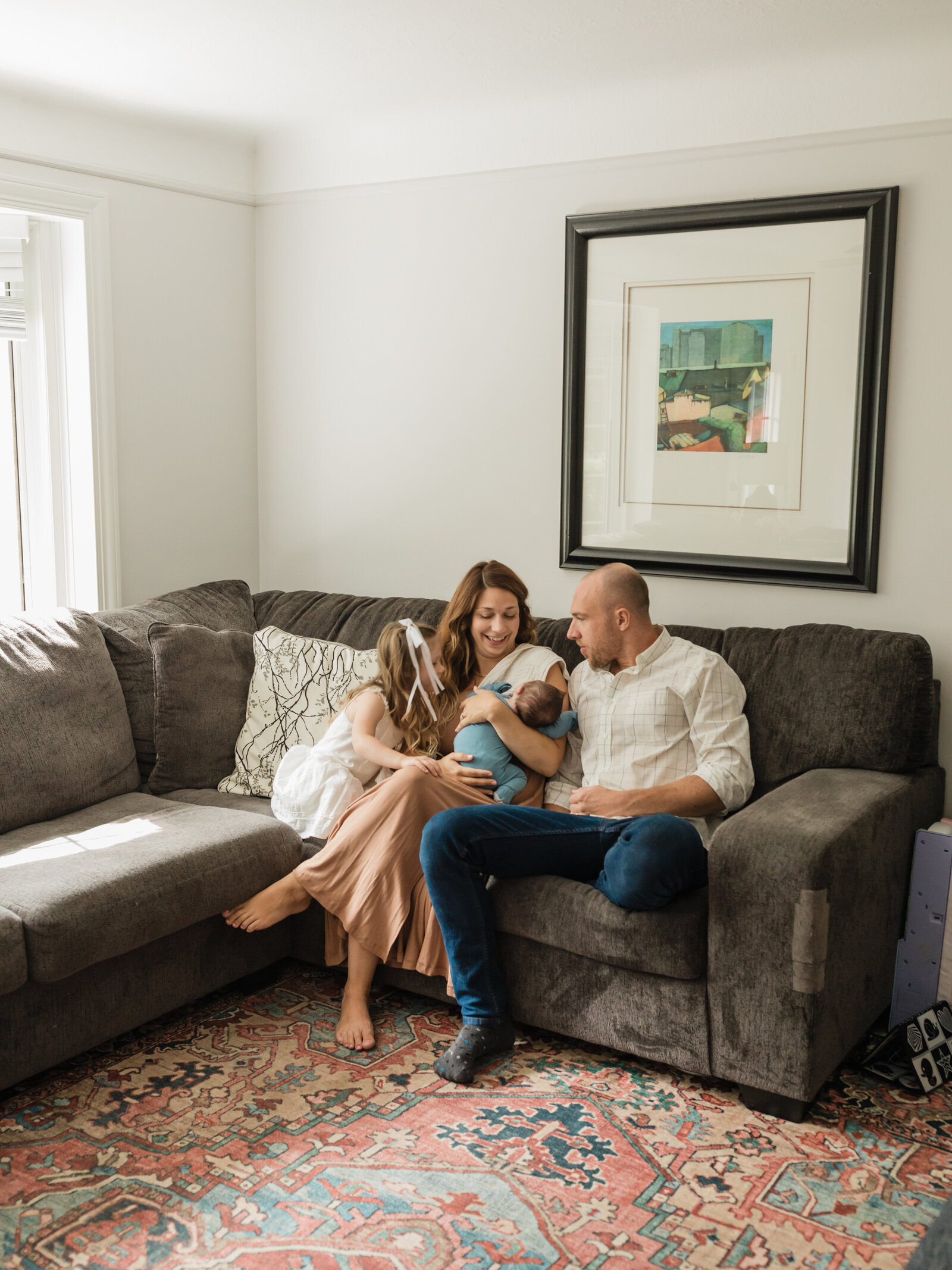 mom and dad holding newborn baby boy for in home lifestyle session