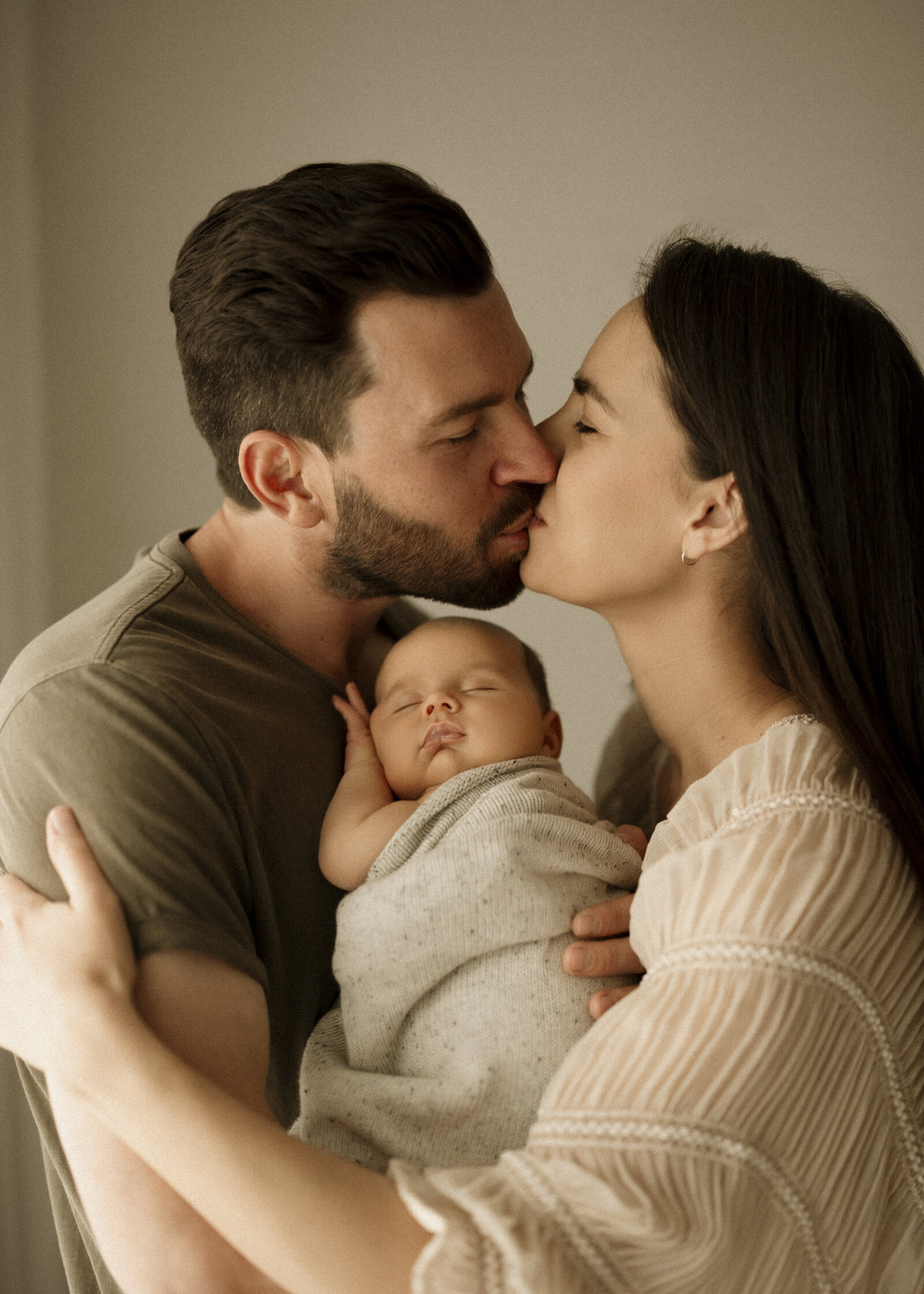 Classic newborn family portraits in Perth – simple, elegant, and focused on the connection between parents and baby.