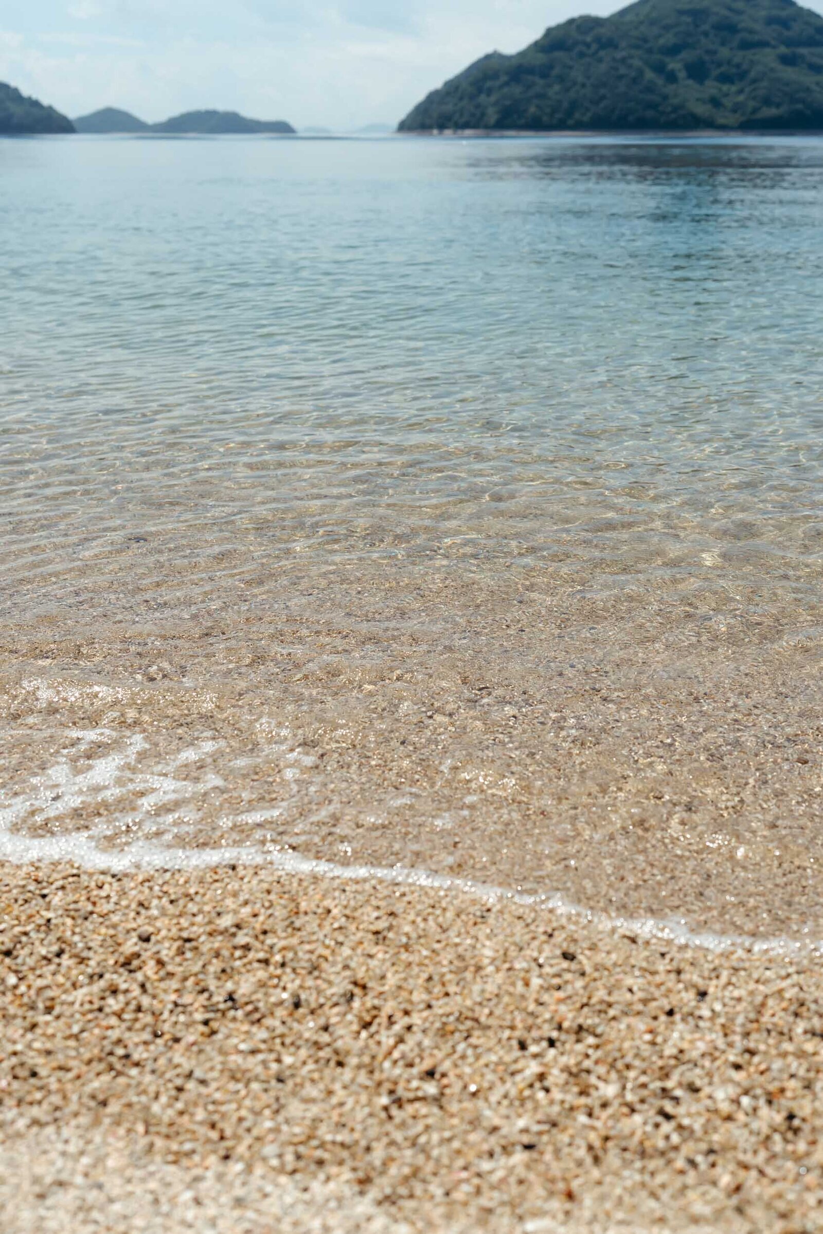 Still waters of the Setonaikai Sea in Hiroshima, evoking peace and quiet with soft reflections and gentle waves.