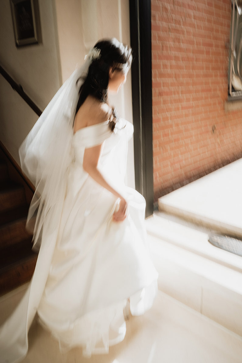 blurry nostalgic image of a bride walking at the connaught hotel in london