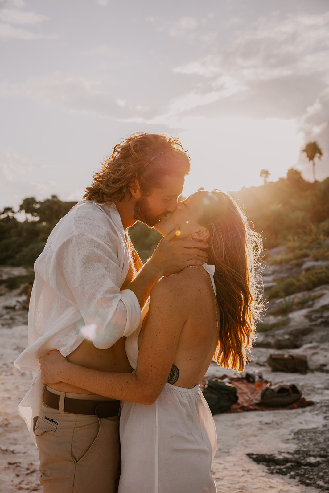 eloping couple kiss at sunset