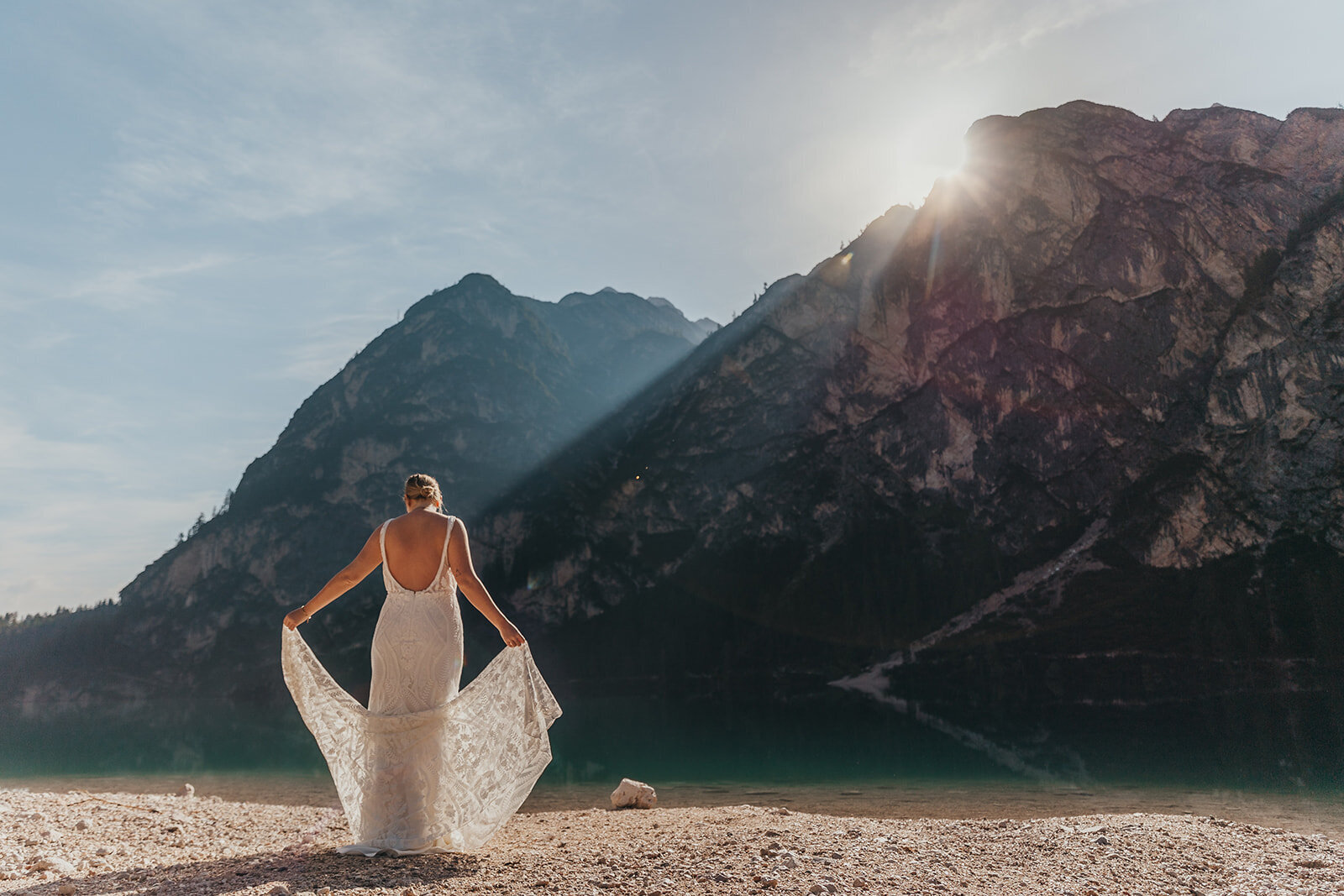 bride poses by lake